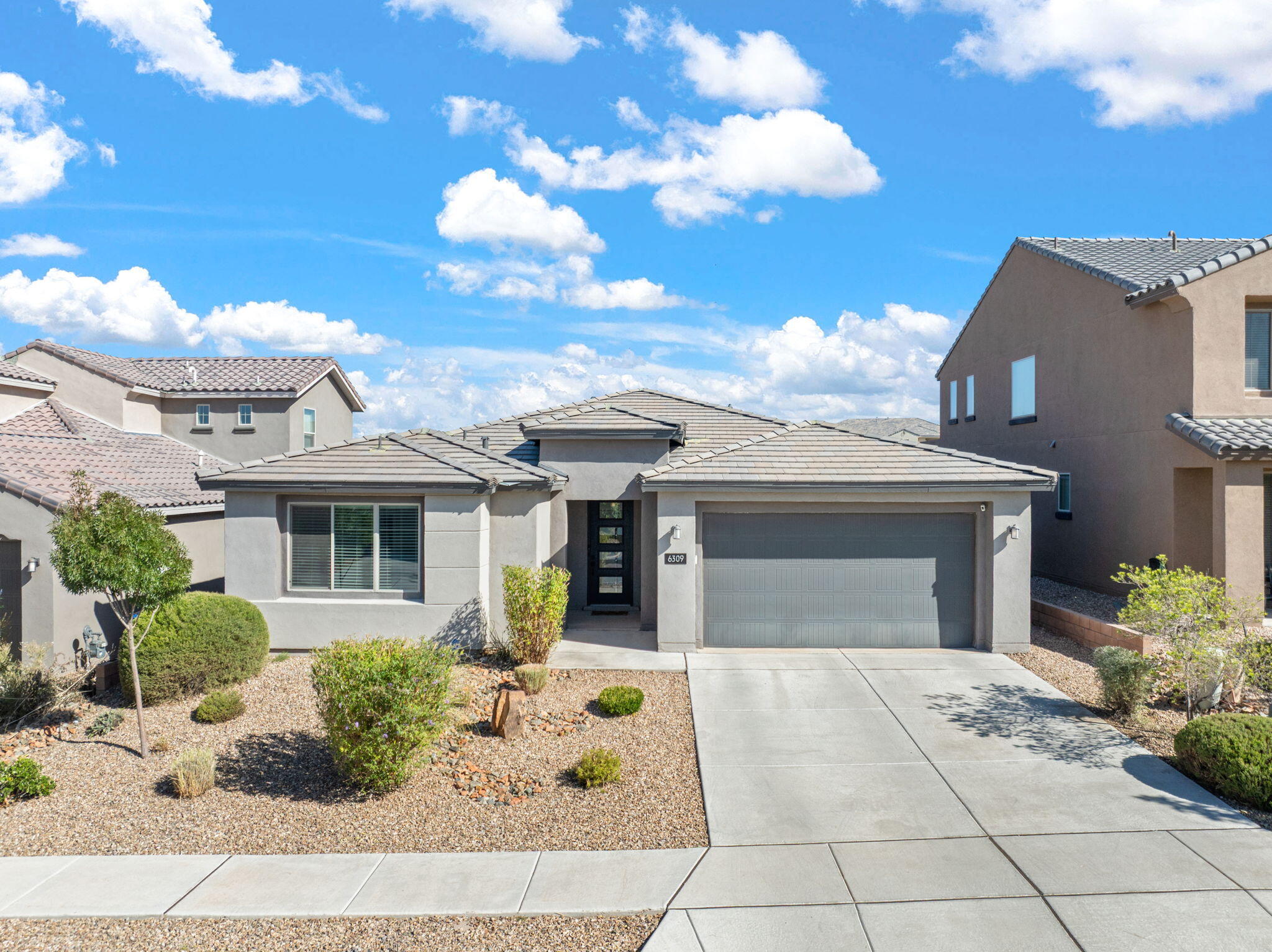 Designed for ease & modern living, this Single-Story home offers a rare combination of space, privacy & walkable convenience. A superior lot with Mountain Views, this 2019 Pulte home is set within a secure gated community. The 2,679-square-foot layout feels calm and intentional the moment you step inside--tall ceilings, consistent luxurious finishes, neutral tones & sunlight that carries through every room. The Kitchen is the heart the home with an oversized island that easily handles everyday meals, weekend baking & casual gatherings. The floor plan flows beautifully, with the Owner's Suite thoughtfully placed nearest the mountains, a second bedroom with an en-suite bath & walk-in closets for all four bedrooms. French doors open to a flexible office or bonus space
