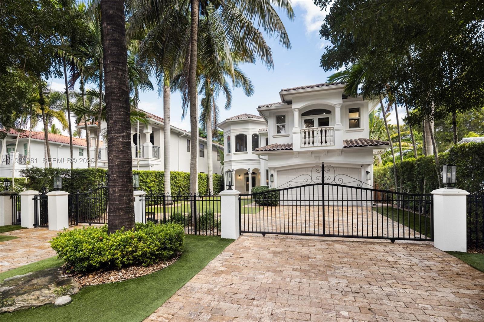 A gated Mediterranean-inspired retreat in South Coconut Grove, this two-story residence blends elegant design with seamless indoor-outdoor living. A dramatic central staircase anchors the open-plan main level, featuring a vaulted living room, formal dining, and a chef’s kitchen with access to private outdoor terraces. The lush backyard offers a pool with fountains, spa, summer kitchen, and covered patio. Upstairs, the expansive primary suite boasts dual walk-ins, a spa bath, and a grand private terrace. Designer cabinetry, volume ceilings, and a voluminous second-floor living area complete this timeless Grove haven.