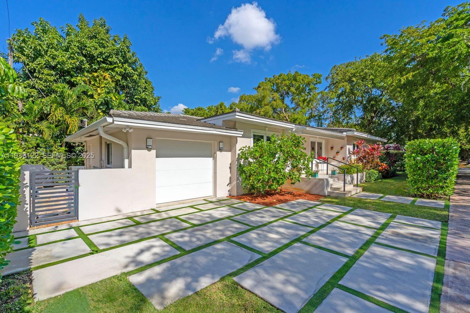Stunningly remodeled 3 bedroom, 2 bath residence located on one of Coral Gables’ most iconic and tree canopied streets. Fully renovated in 2019, this home offers a rare blend of timeless Gables character and contemporary sophistication. The property faces south, allowing natural light to illuminate the interiors throughout the day and enhance the home’s connection to its lush, thoughtfully landscaped surroundings.Inside, the open concept layout showcases beautifully refinished hardwood white oak flooring, vaulted tongue-and-groove ceilings, and carefully curated finishes that elevate every space. The custom kitchen features Bosch appliances, Italian cabinetry, a large central island, sleek Blanc countertops, and built-in shelving, creating a refined environment ideal for both daily living and entertaining.The residence underwent a complete systems upgrade in 2019, including new electrical and plumbing, offering long term reliability and peace of mind. Additional features include a one car garage, an elegant modern driveway design, and an inviting front entry framed by mature tropical landscaping.Situated just moments from the best of Coral Gables, including The Biltmore, Granada Golf Course, Merrick Park, and top rated schools, this home delivers exceptional lifestyle, design, and location in one of the city’s most desirable pockets.