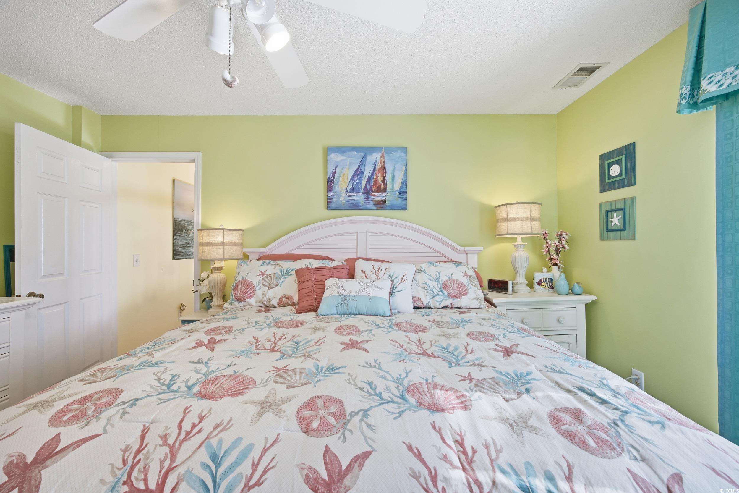 Bedroom featuring ceiling fan and a textured ceiling