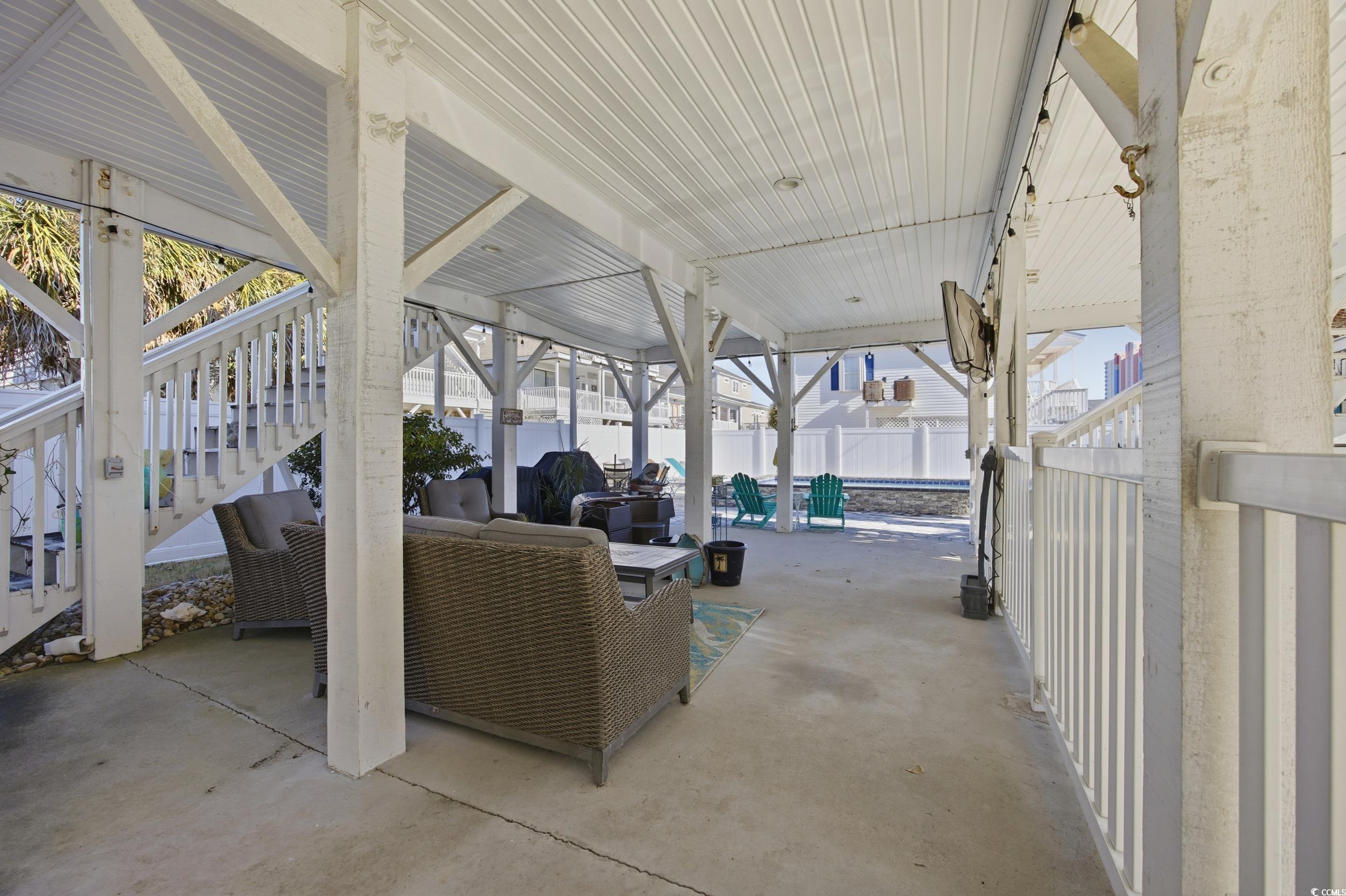Fenced backyard with stairs, a patio, and outdoor lounge area
