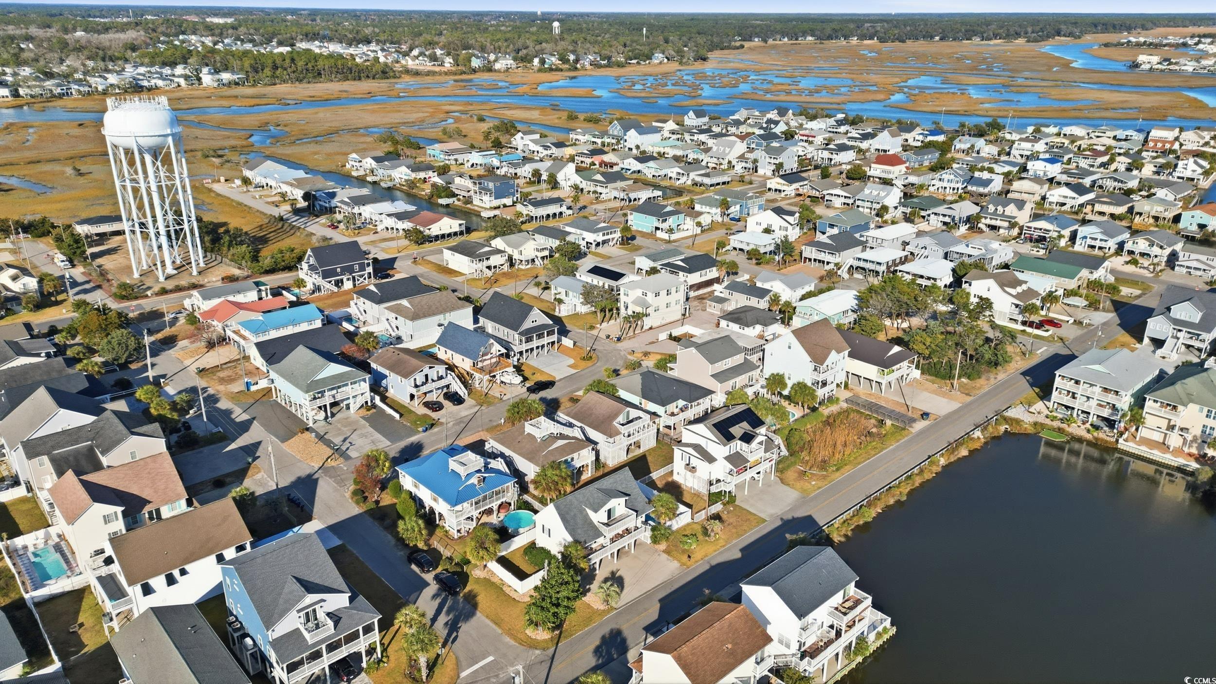 Aerial overview of property's location with a nearby body of water and nearby suburban area