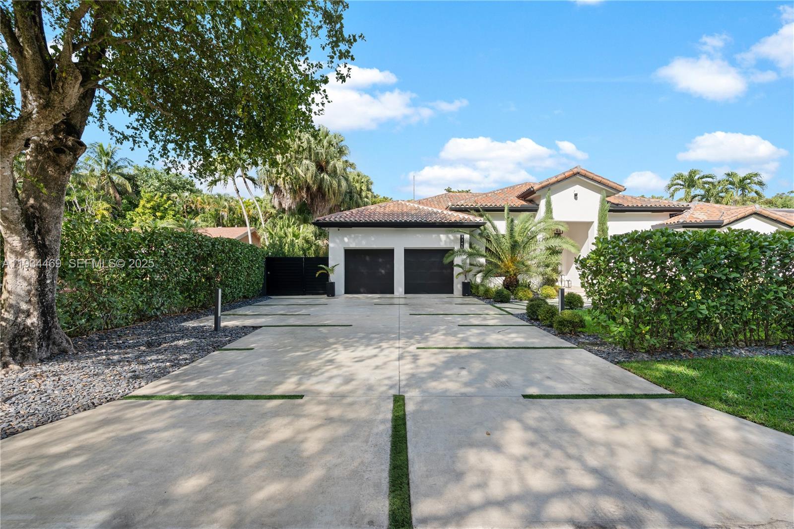 New Listing in North Pinecrest! Stunning 4BD/5BA home featuring 10-ft ceilings, modern finishes and a open layout filled with natural light. Spacious primary suite with spa-style bath with his and hers custom closets plus 3 additional  ensuite bedrooms and a flex room ideal for a guest suite or office with separate entrance. New energy-efficient AC systems with linear diffusers, PureSonic water softener, electric car charger, and a custom garage with built-in cabinetry. Located on a quiet cul-de-sac for added privacy. The backyard has putting green and artificial turf perfect for entertaining with a summer kitchen and pergola. Prime North Pinecrest location close to top schools, parks, and shopping.