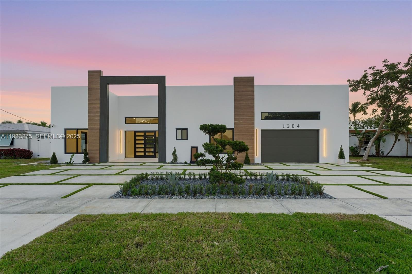 Welcome to SEABREEZE, a boutique waterfront masterpiece offering refined coastal living with direct ocean access. This brand-new 2025 custom residence features 3 bedrooms, 3.5 bathrooms, and 2,223 square feet of thoughtfully designed living space, crafted over two years with meticulous attention to detail, premium materials, and all permits in place.Designed for both entertaining and everyday living, the one-story floor plan showcases soaring 12-foot ceilings, elegant European Padron tile flooring, and an abundance of natural light throughout. The chef’s kitchen is appointed with Thermador stainless steel appliances, custom European-style cabinetry, and sleek modern finishes. Spa-inspired bathrooms feature DAX shower panels, while LED lighting, linear A/C vents, and high-end construction elevate the home’s modern aesthetic.Enjoy seamless indoor-outdoor living with a hardwood ceiling covered back porch overlooking the canal. Situated on an 8,028 SF lot with 41 feet of waterfront, the property offers direct water access, a private dock, seawall, and one fixed bridge—ideal for boating or jet skis. Additional features include a private entrance flex suite, attached one-car garage, concrete circular driveway with ample parking, and golf cart parking.Located east of Federal Highway with quick access to I-95, this exceptional waterfront home delivers luxury, functionality, and the ultimate South Florida lifestyle.