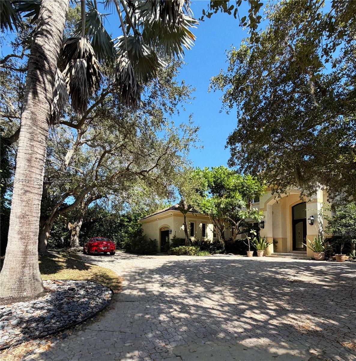 Strategic Price RepositioningPRIVATE OLD CUTLER OAKS ENCLAVECompletely Renovated in 2025 | Timeless Elegance in an Exclusive Gated SettingA stately custom residence tucked within Private Old Cutler Oaks, an intimate, gated enclave of just 15 distinguished homes, complete with a private tennis court and set on a quiet, picturesque cul-de-sac. This is refined Pinecrest living at its absolute finest.Thoughtfully renovated in 2025 with impeccable taste and uncompromising quality, the home makes an unforgettable first impression. A grand foyer opens to a breathtaking double-height formal living room, immediately establishing a sense of elegance, volume, and architectural presence. A gracious formal dining room flows seamlessly, ideal for elevated entertaining.The gourmet chef’s kitchen is beautifully appointed and opens to a sun-filled breakfast area and an expansive family room—perfect for both effortless daily living and memorable gatherings. High-impact windows and doors and new light oak flooring enhance the entry, common areas, hallways, and powder room, while all bedrooms feature luxurious taupe carpeting for warmth and comfort.The residence offers a private guest suite and a refined library/office, while the lavish primary suite serves as a serene retreat with a sumptuous, spa-inspired bath. Every bedroom is en-suite, showcasing open, tranquil vistas and custom built-ins throughout.