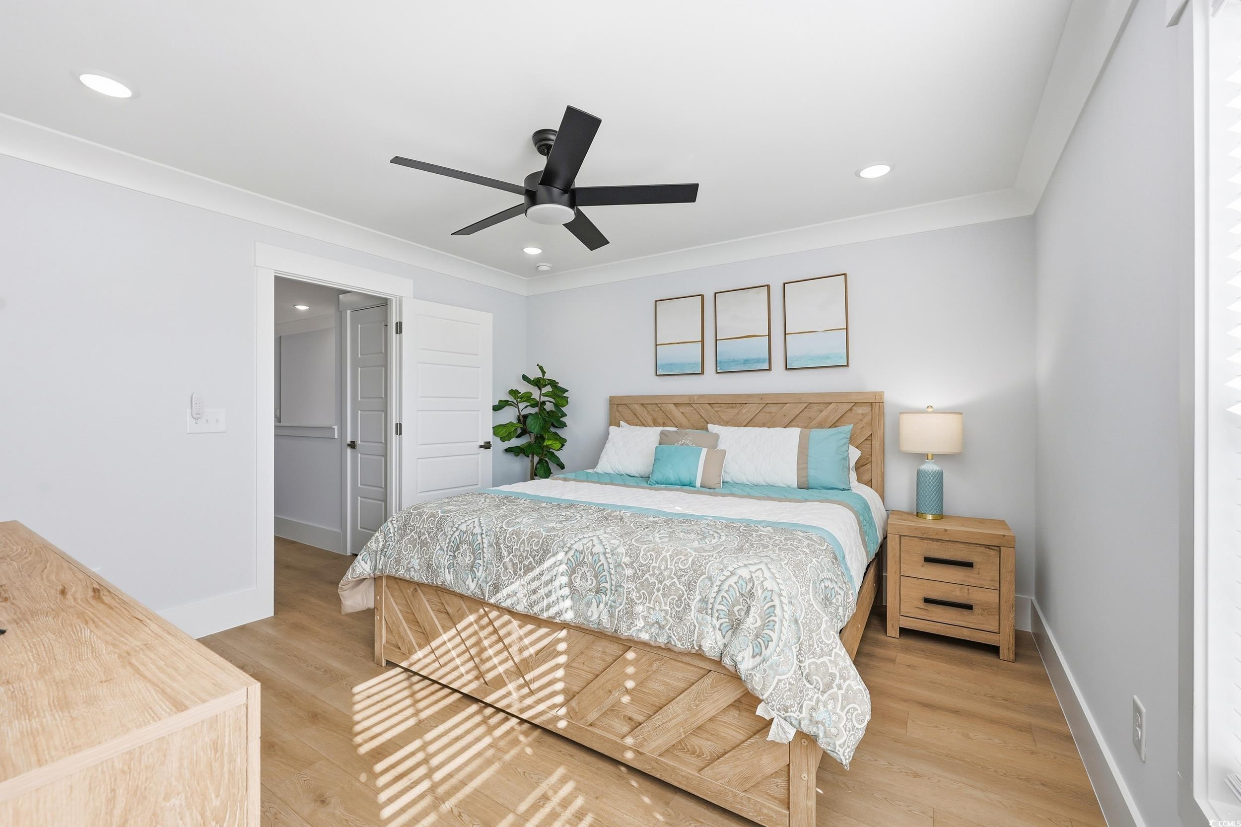 Bedroom featuring light wood-type flooring, crown molding, ceiling fan, and recessed lighting