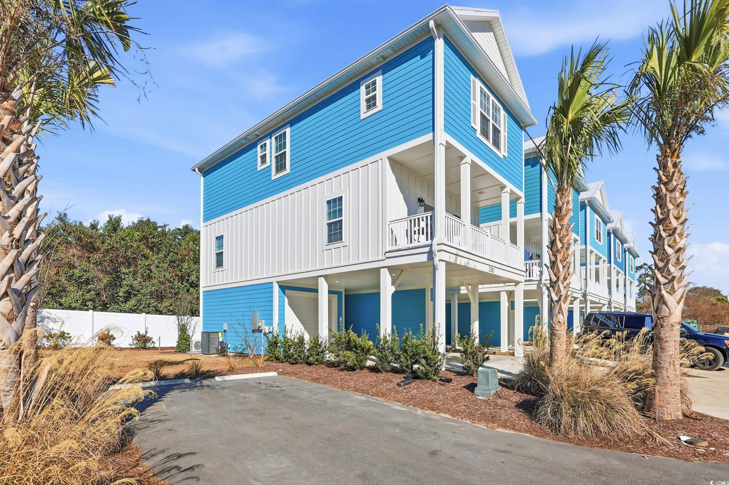 View of front facade featuring board and batten siding and a balcony