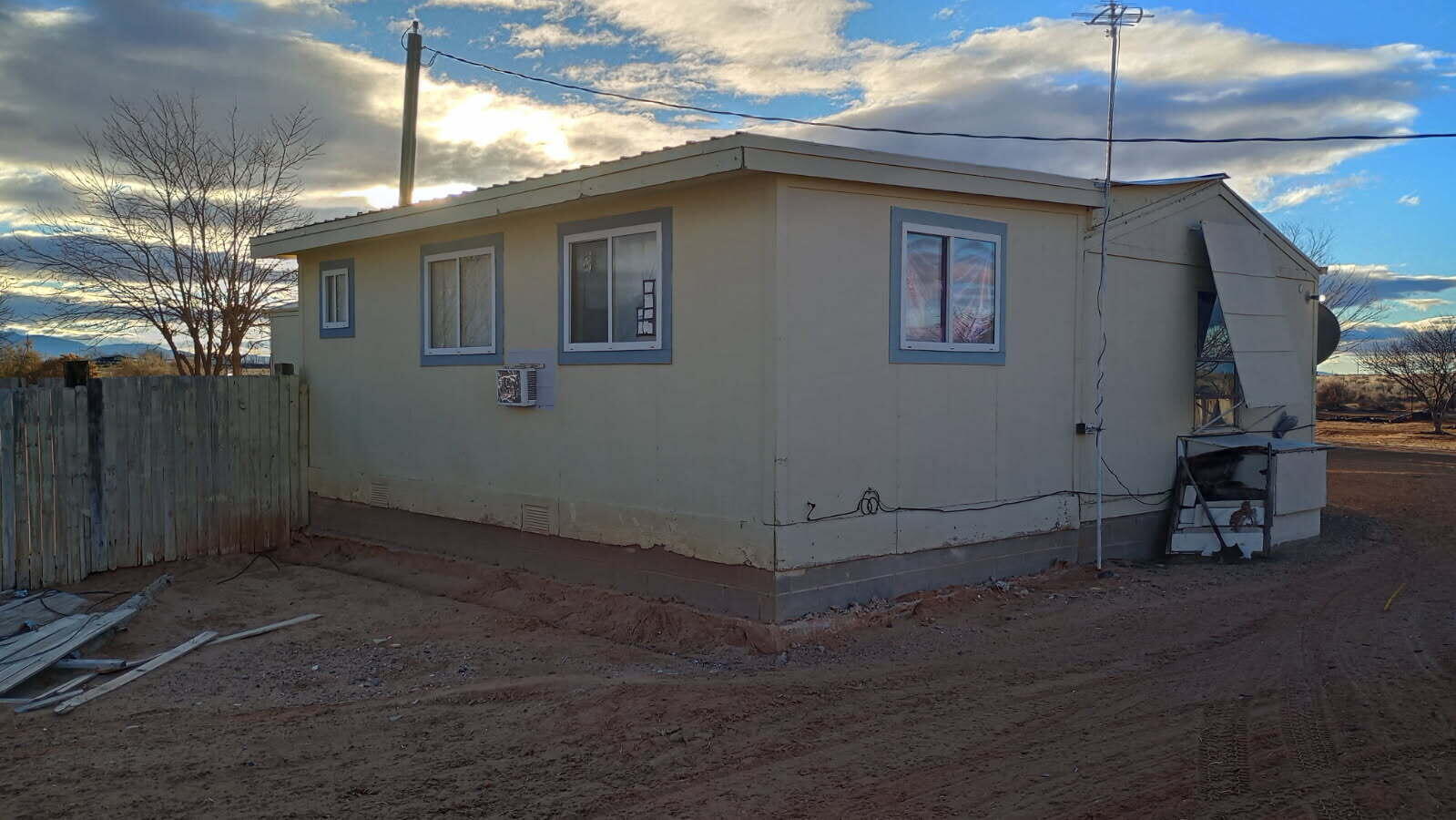 Rare opportunity to own a spacious 3-bedroom, 1.5-bath manufactured home with a site-built addition on 1.43 acres in the quiet Rancho Rio Grande subdivision of Belen. This 1,596 sq ft 2001 model offers full land ownership with no lot rent and plenty of space to enjoy country living. Features include propane central heat, a rubber roof installed in 2019, and private well water recently serviced. Interior needs light updates, making it ideal for a buyer with vision. Clean, and move-in ready with minor cosmetic work.