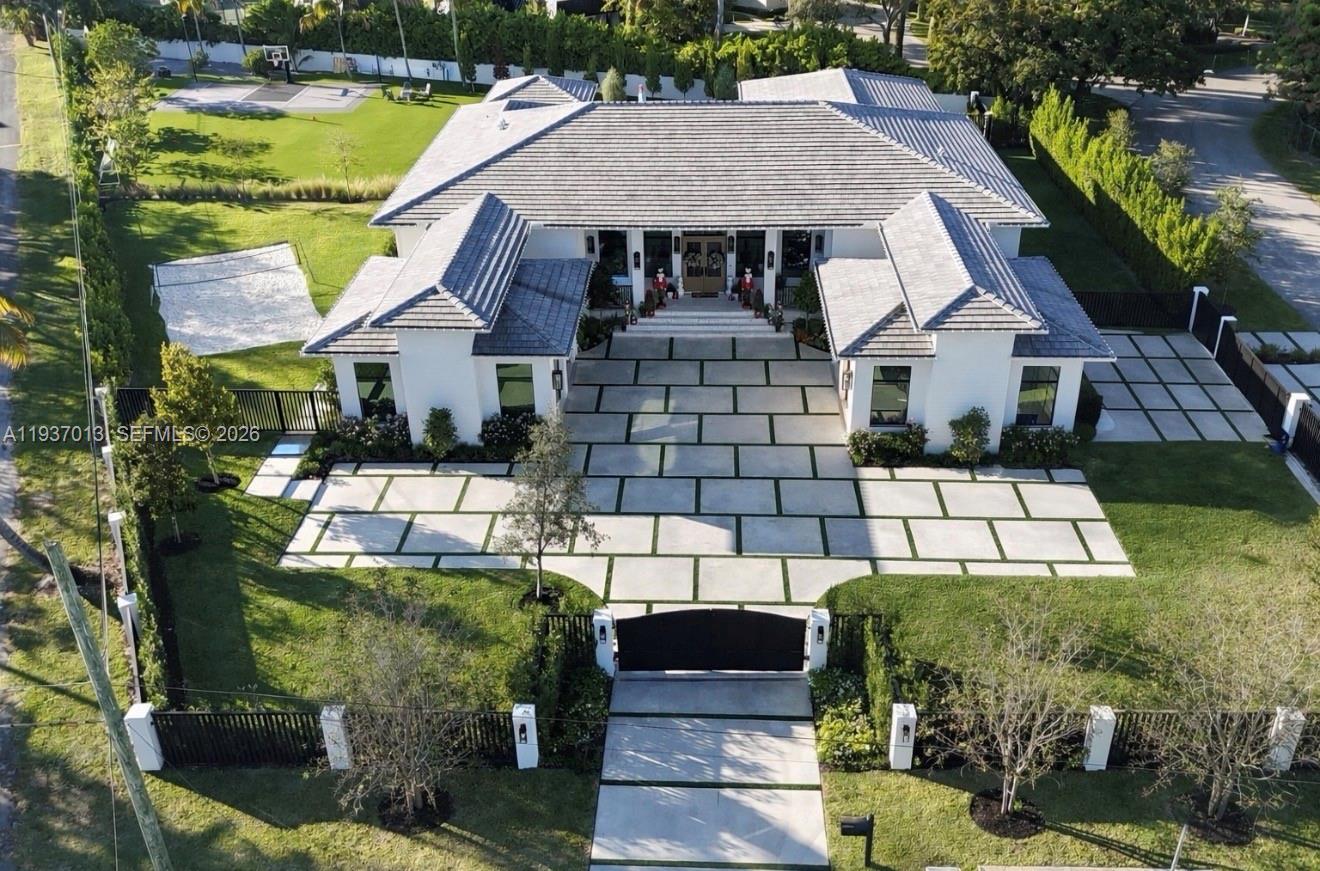 Step into refined modern living in this single story newly built (2025) custom home set on a 39,906-SF lot in sought-after North Palmetto Bay. Offering 7,400 total SF with just under 5,000 SF under A/C, this thoughtfully designed 6-bedroom, 6-bath residence blends luxury, comfort, and functionality with high-end finishes and custom details throughout.The home features soaring 13’ ceilings, walk-in closets, custom built-ins, and expansive living spaces ideal for both everyday living and entertaining.Designed for seamless indoor-outdoor enjoyment, the property showcases exceptional outdoor living with a resort-style pool, covered terrace with outdoor kitchen, spacious gazebo, basketball court, beach volleyball court, and multiple entertaining areas—perfect for hosting family and guests.A rare opportunity to own a newly built modern estate offering space, privacy, and lifestyle in one of Palmetto Bay’s most desirable locations.