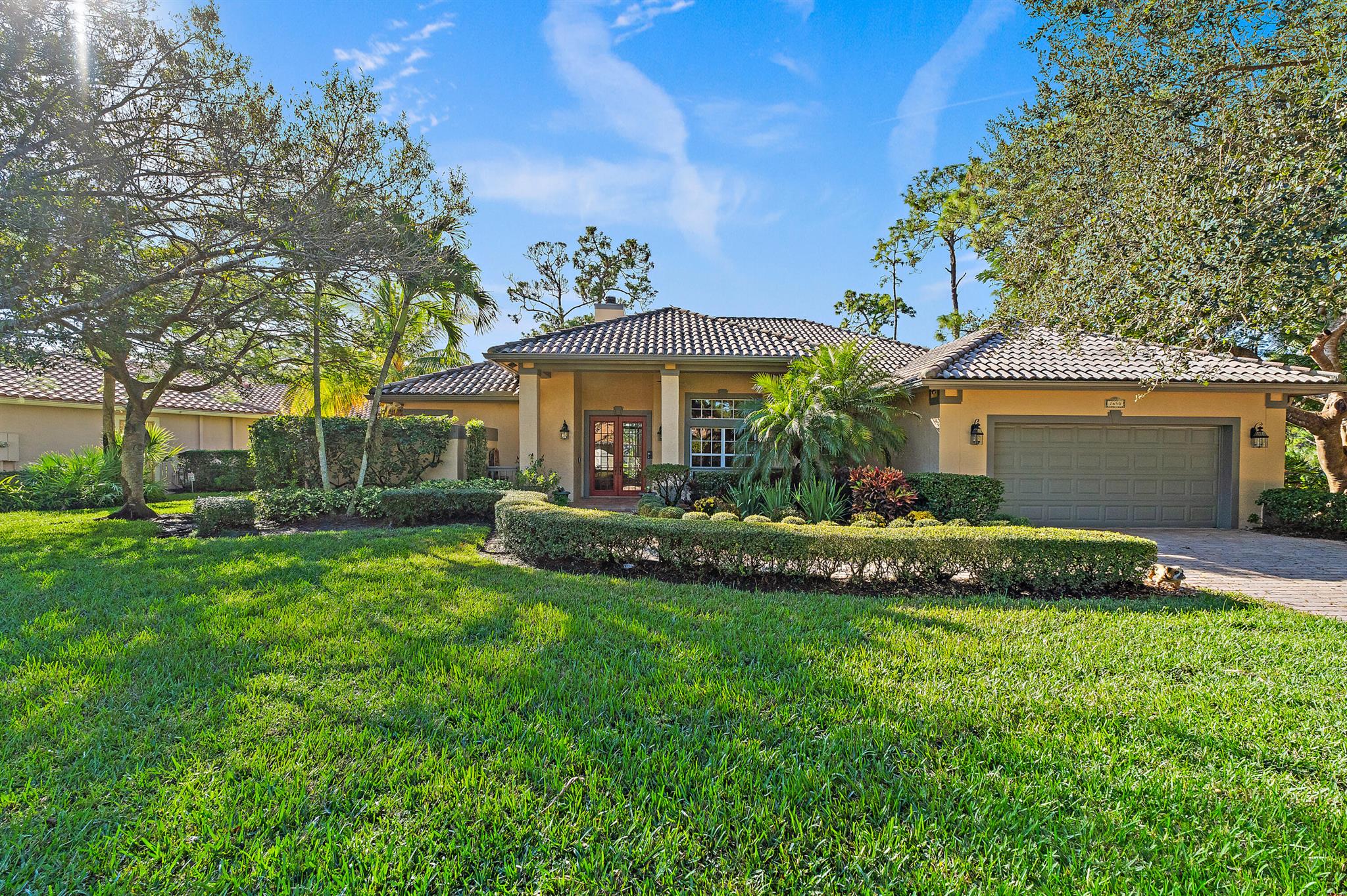 Tucked away in the coveted waterfront community of Locks Landing, this exceptional 4-bedroom lakeside estate is set on an **oversized corner lot, one of the largest in the neighborhood offering rare privacy, natural beauty, and endless potential. Surrounded by towering native trees and protected habitat, the home enjoys peaceful lake views through the trees, creating a tranquil, nature-forward setting. A charming double-sided fireplace anchors the living room and primary suite, adding warmth and character while enhancing the home's inviting atmosphere.Designed with flexibility in mind, one of the bedroom suites features a private exterior entrance, making it ideal for guests, extended family, or a private retreat. The expansive lot provides ample room to customize. Whether you envision adding a third garage, additional storage, a luxury-sized pool, an addition, a guest house, or a garden oasis.Residents enjoy access to a private marina, scenic wooded nature trail. just 100 yards from marina. Boat slips may be available through the homeowner's association, offering convenient access to the water. The enchanting trail continues from the north side of the marina along the Okeechobee Waterway to Locks Park, approximately a half-mile stroll beneath a lush canopy of trees perfect for walking, biking, or simply enjoying the outdoors.This is a rare opportunity to own a lakeside home with space, privacy, and connection to nature in one of the area's most desirable waterfront communities.