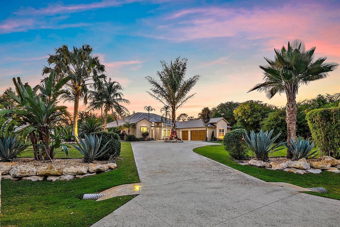 Welcome to ''Elephant Walk'', a private Palm City estate of rare distinction, on 5.8 pristine acres in the exclusive Stuart West equestrian community of Martin County. Designed in 2012 with CBS construction, this Southwestern-inspired residence blends architectural character with refined Florida luxury. Offering 3,667 sq ft under air and 6,277 sq ft total, the estate includes a 3BR, 3.5 BA Main Home plus a private 1BR/1BA Guest Cottage ideal for guests or extended stays. Rich African mahogany flooring, travertine tile, soaring 10-14 foot ceilings, impact glass, crown moldings, and Electrolux Icon appliances showcase exceptional craftsmanship throughout. Car collectors will appreciate the 6-8 car garages: attached 3-car garage plus air conditioned 1,710-sq-ft detached 5-car garage/workshop.