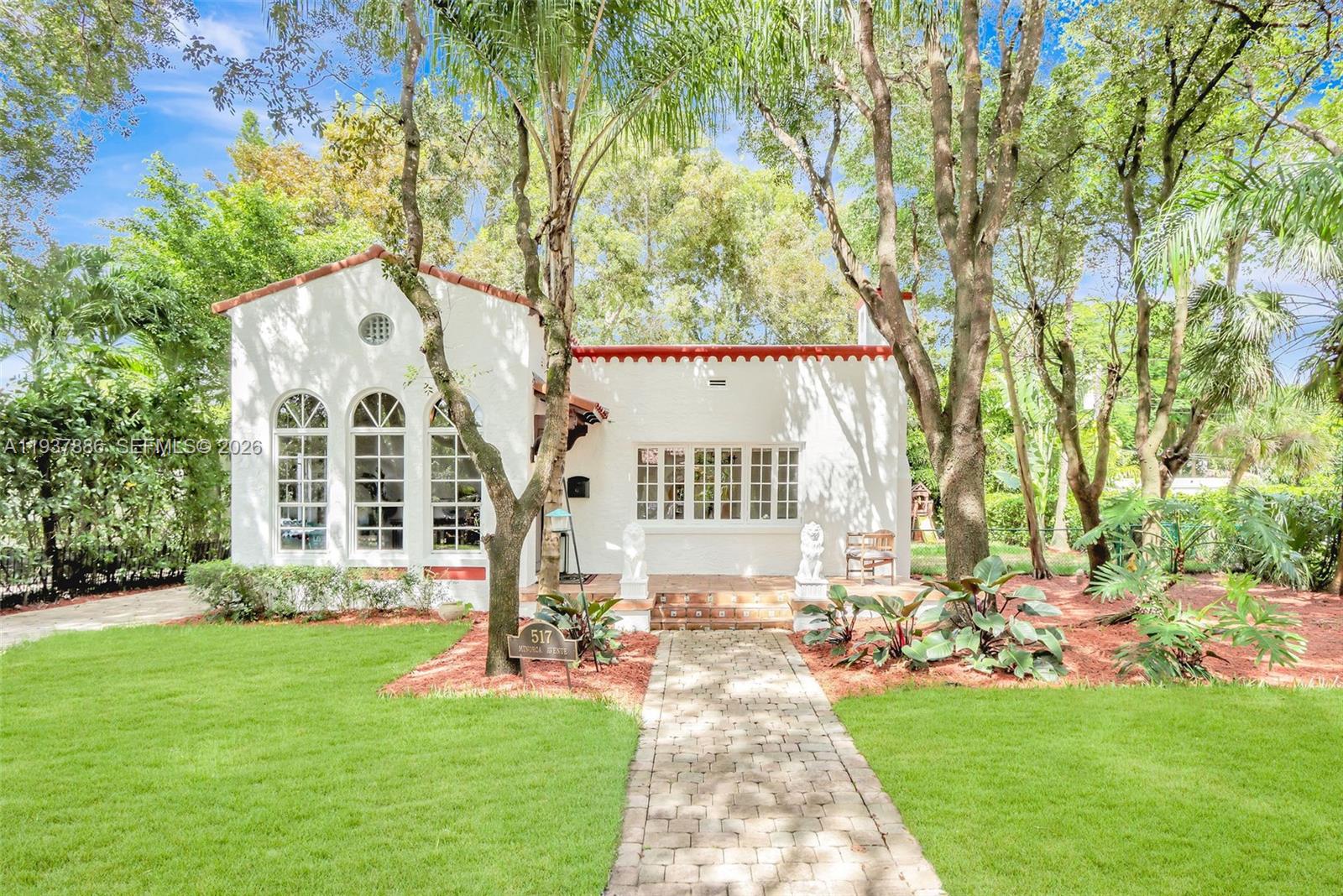 This enchanting Old Spanish home is situated on an oversized 8,475 sq. ft. lot, offering ample space for a pool and home expansion. Located just a short walk from downtown Coral Gables, you'll enjoy easy access to renowned shops and restaurants. Inside, you're welcomed by a grand foyer with high vaulted ceilings and large glass windows that fill the space with beautiful natural light. The home features 3 bedrooms and 2 bathrooms (2/1 Main House + 1/1 Guest House), along with a warm and inviting living room highlighted by a charming wood-burning fireplace. The well appointed kitchen boasts wood cabinetry, stainless steel appliances, and top-of-the-line Wolf and Sub-Zero appliances—perfect for any home chef. This is a rare opportunity to own a timeless Coral Gables gem with room to grow.