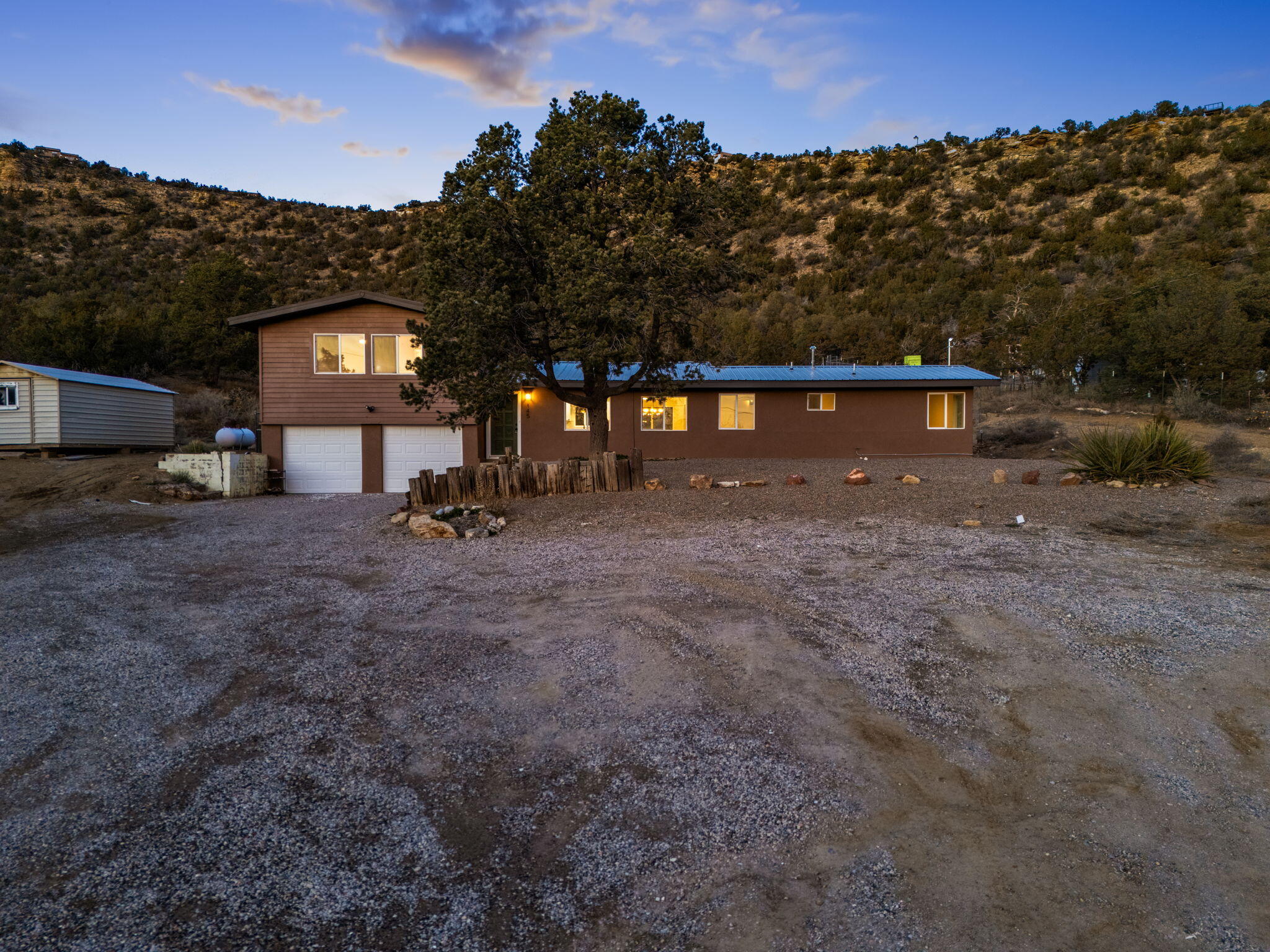 Newly renovated mountain retreat nestled in the peaceful East Mountains! Situated on 2 acres, this beautifully updated home blends modern finishes with rustic charm. Recent improvements include fresh paint, new flooring, updated lighting, and fully remodeled kitchen and bathrooms. Major system upgrades have also been completed, including a new septic system, termite treatment, well upgrades, and upgraded electrical with a transferable 1-year warranty. Surrounded by mature trees, the property offers privacy and serenity just minutes from I-40. Plenty of space for outdoor entertaining, gardening, or relaxing under the stars--this move-in ready gem is a must-see!