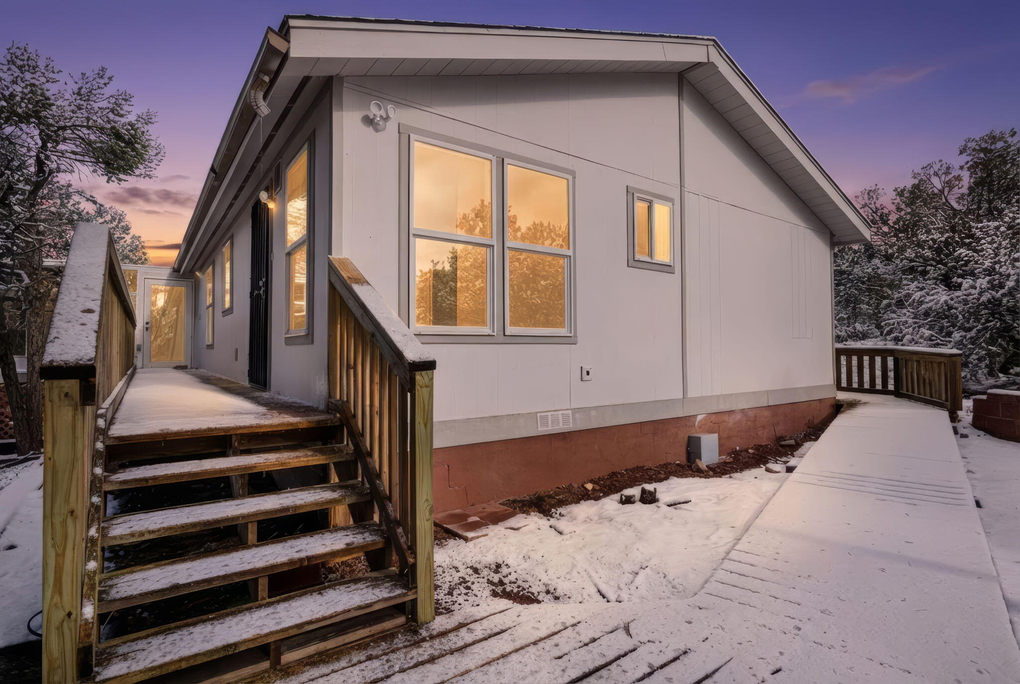 Newly renovated, 3-bed, 2 full bath manufactured home offers 1,672 SF of living space on a 2 acre lot. Featuring new vinyl & carpet flooring, new interior & exterior paint, and light fixtures 2025. New refrigerated air combo unit 2025. New roof 2025. New water heater 2025. The open-concept layout includes a spacious living area and primary suite with a walk-in closet and full bath, set apart from the additional bedrooms for added privacy. A heated sunroom can easily serve as a home gym, indoor garden, office, or relaxing retreat. Step onto the new wraparound deck and experience serene, private living, tucked among the trees for a true mountain escape. Storage shed. There's plenty of space to add a casita or workshop. Enjoy quiet country living just 20 minutes from the city. A must See!