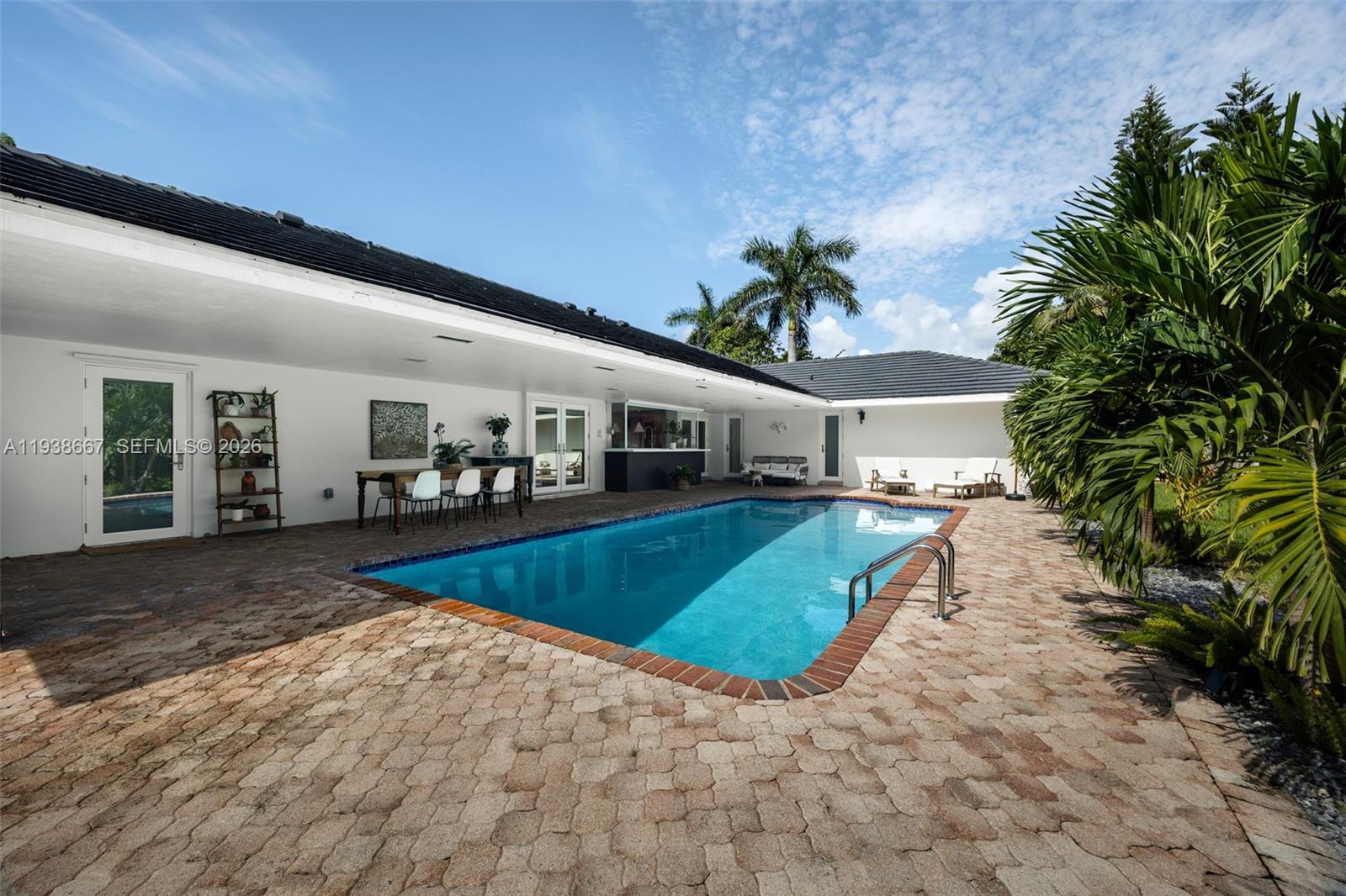 Tucked beneath swaying palms on a coveted Palmetto Bay corner lot, this renovated 4-bedroom, 2-bath pool home delivers true South Florida living. Lush tropical landscaping surrounds a private backyard with sparkling pool, covered patio, and mature trees—ideal for relaxing or entertaining year-round.The renovated kitchen features high-end appliances and overlooks the pool and outdoor living areas. A charming “secret garden” on the side of the home offers space for herbs, vegetables, or a quiet retreat.Additional highlights include a 2-car garage with side-street access, circular driveway with ample guest parking, and easy access to Old Cutler Road. A rare Palmetto Bay opportunity blending privacy, functionality, and lifestyle.