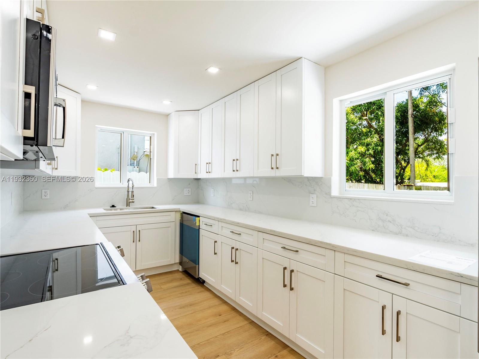 Modern kitchen with designer features at 254 4th St - Home in Dania Beach