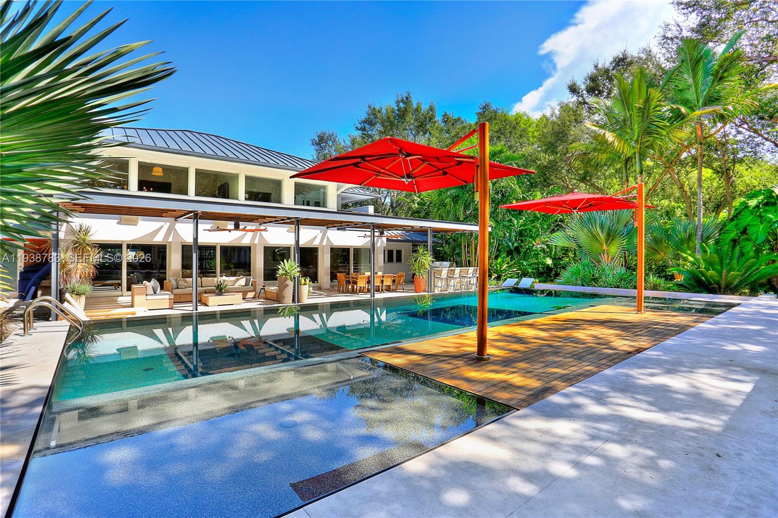 Stunningly updated from top to bottom w/ the finest finishes & details like white oak wood floors throughout, 1100 bottle wine cellar, Sonos sound system, Lutron lighting & power shades, outdoor living room including infinity edge pool with child pool fence, feature wall, summer kitchen w/ poured concrete counters, fireplace & cantilevered TUUCI umbrellas. Open living spaces w/ mahogany impact doors, gorgeous exposed beamed ceiling, gourmet kitchen w/ butler’s pantry, 3 BR’s down + game room, private 2nd floor primary suite w/ beautiful double door entry offers gracious BR, sitting room, stunning bath & 2 walk in closets. Laundry room, 2 car gar, ½ basketball court, walled and gated 36,153 SF lot in the gated Banyan Lakes neighborhood.