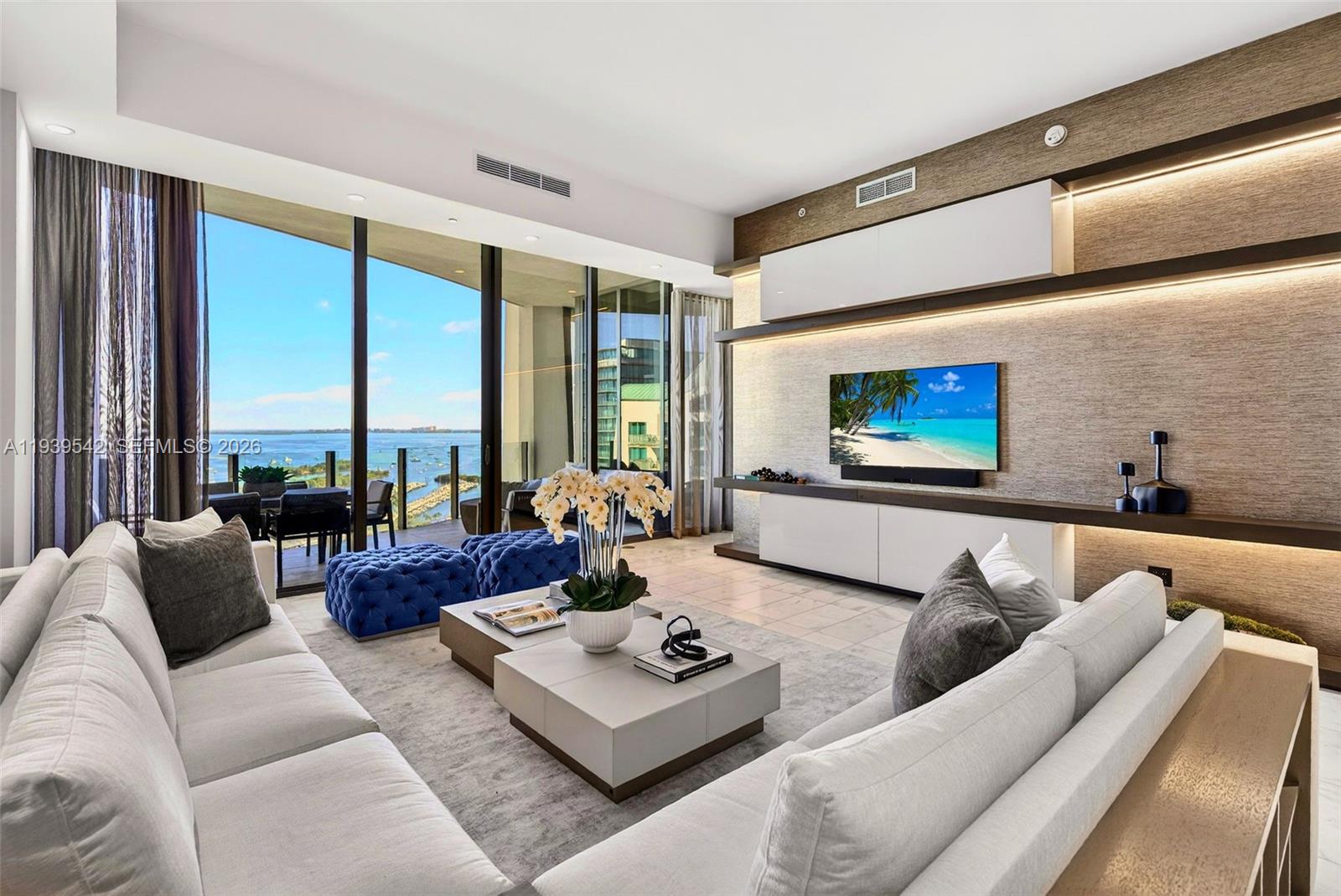 A refined Adriana Hoyos designed residence in coveted Two Park Grove, this 3-bed, 3.5-bath + den spans 2,532 SF and showcases over $1M in upgrades. Elegant marble floors flow throughout, complementing custom built-ins and abundant storage. The sleek Italkraft kitchen features a Sub-Zero fridge/freezer, 5-burner Wolf gas range, Wolf steam oven, microwave, and wine fridge. All bedrooms offer en-suite baths, while the spacious den easily converts to a 4th bedroom. Floor-to-ceiling windows frame bay and pool views, enhancing the home’s seamless indoor/outdoor flow. Residents enjoy resort-style amenities including valet, full-service spa, fitness center, yoga/Pilates studio, theater, multiple pools, and a private restaurant. Located in one of Miami’s most desirable neighborhoods, this turnkey residence offers sophisticated living steps from parks, marinas, and the best of Coconut Grove. Includes 2 assigned parking spaces and storage.