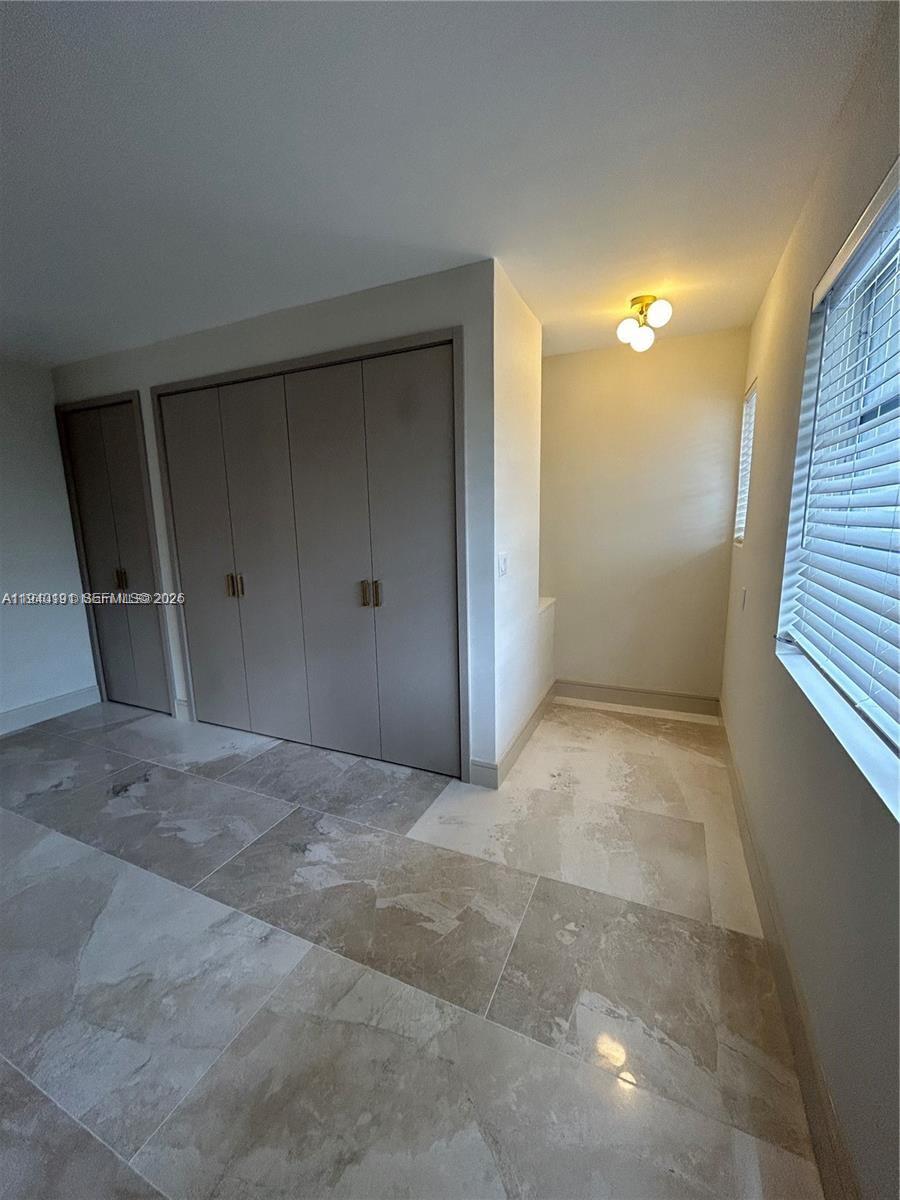 Well-appointed guest bedroom at 1060 92nd - Condo in Bay Harbor Islands