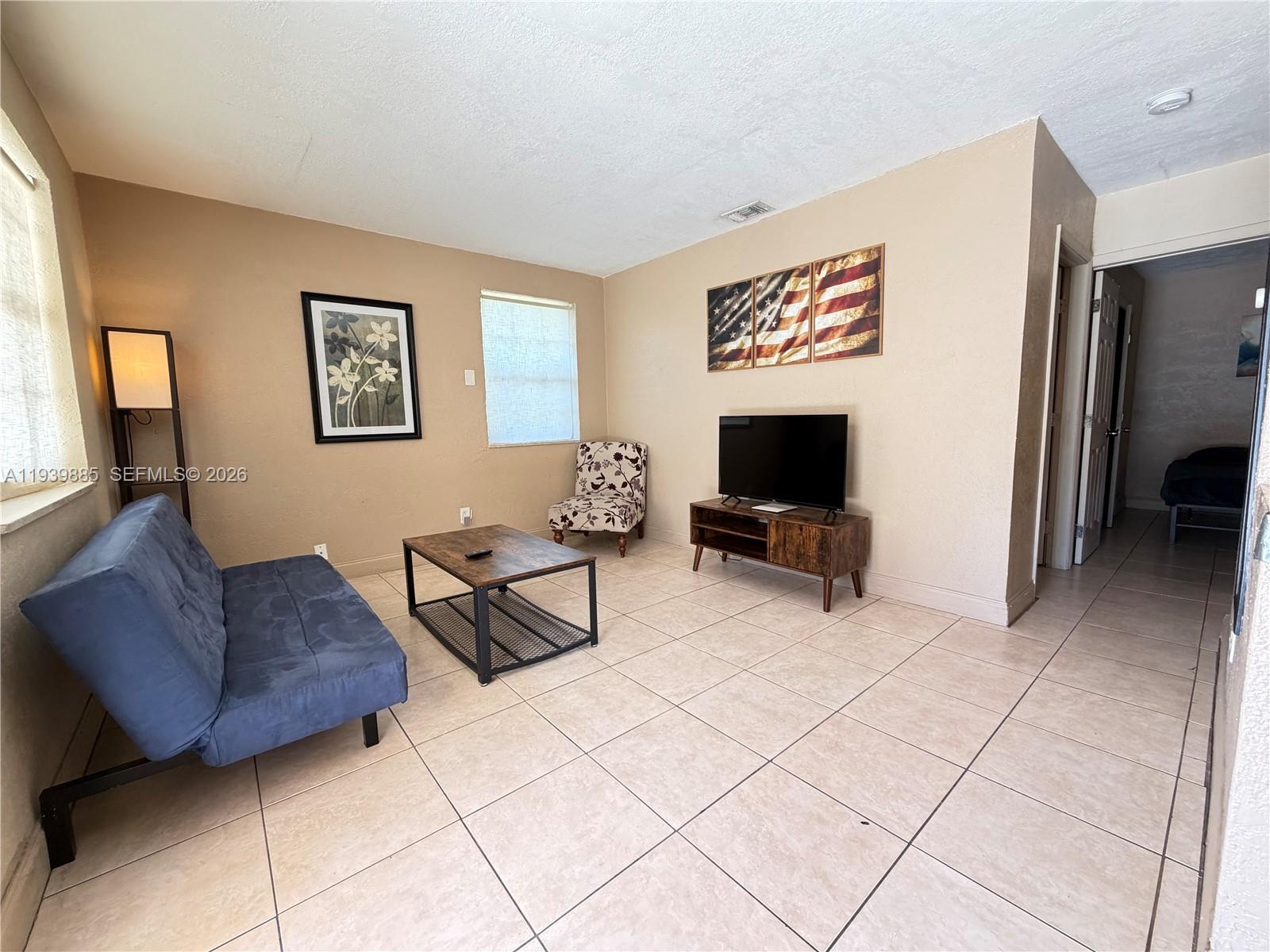 Well-appointed guest bedroom at 212 2nd Ter - Home in Dania Beach