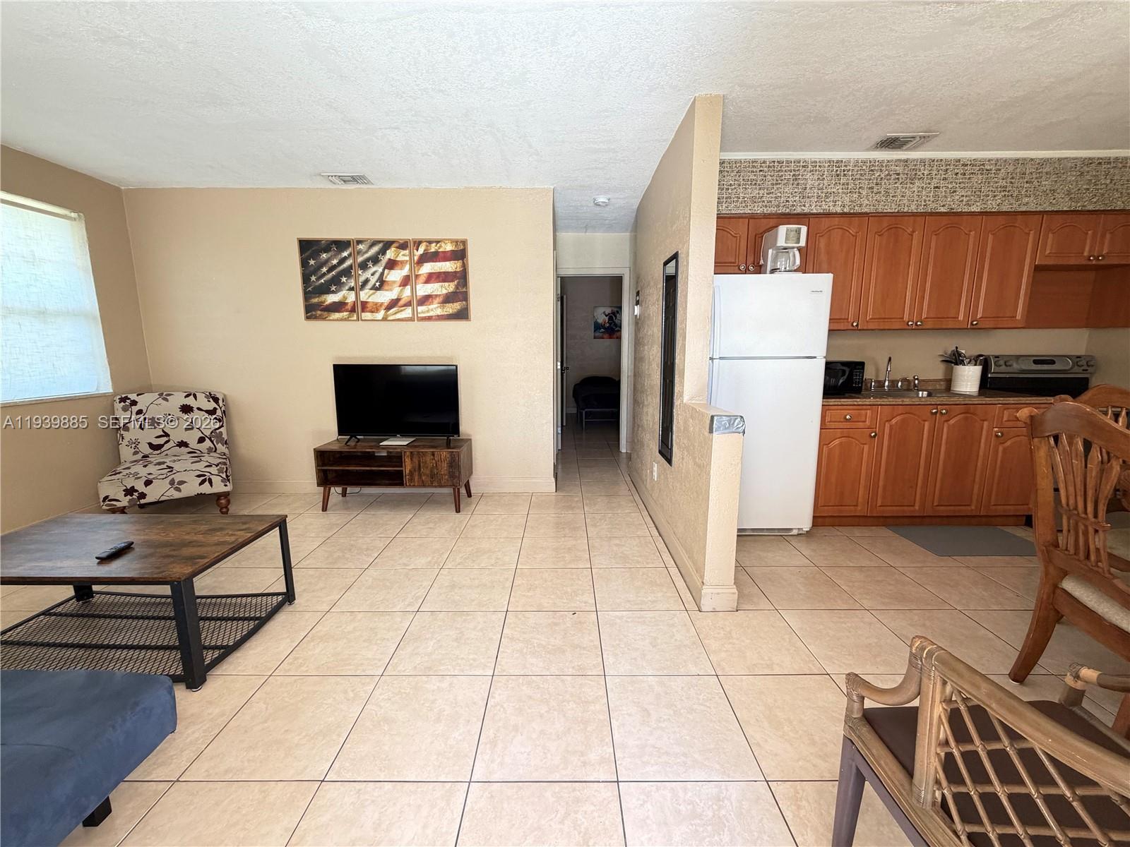 Open-concept living area at 212 2nd Ter - Home in Dania Beach