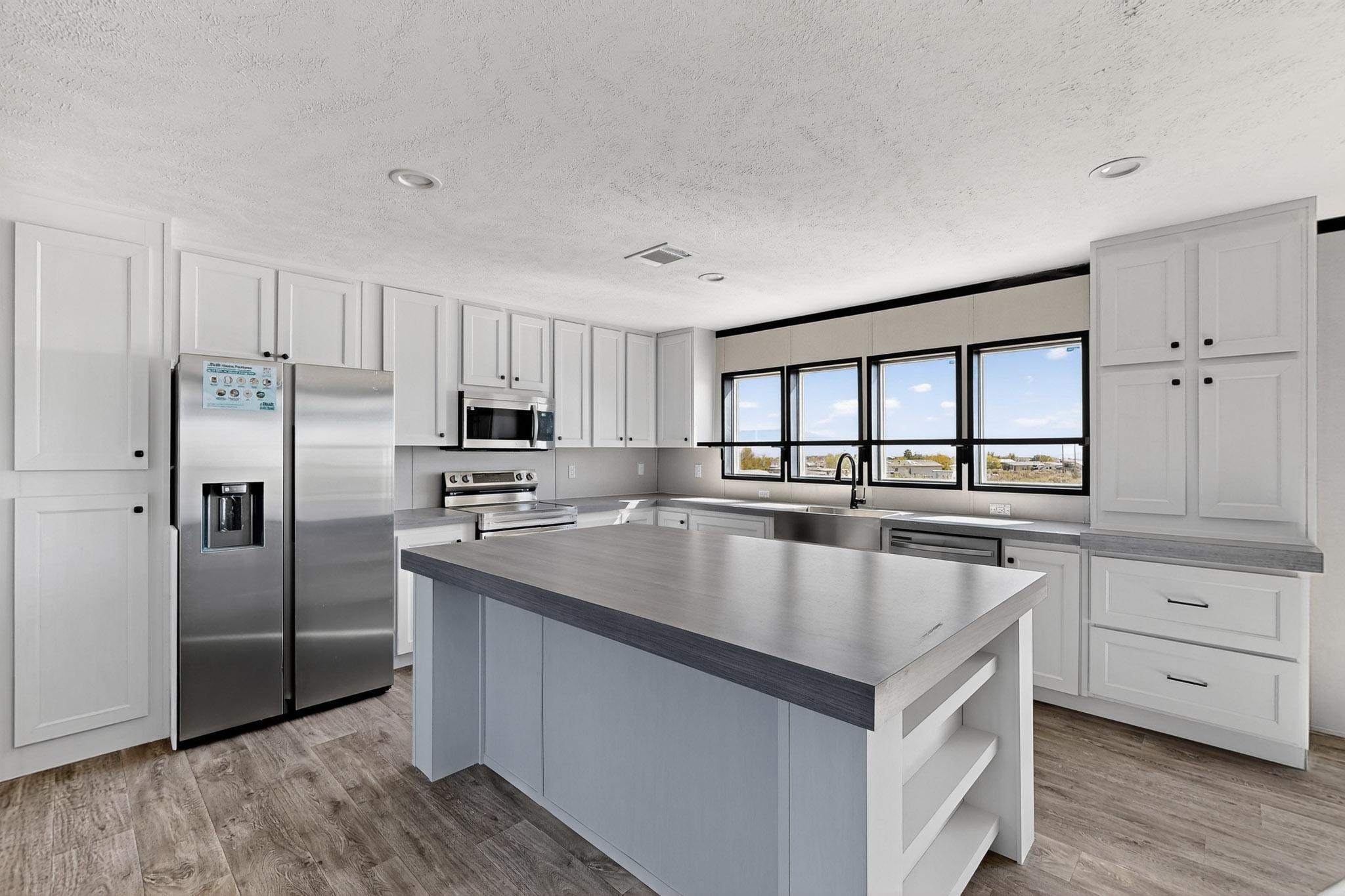 Beautiful Brand New Clayton Home will be ready June of 2026 home will sit on one acre. Close to shopping and yet still feels like country living. In the county but still in Rio Rancho School District. This four bedroom, three bath home has an open floor plan, nice kitchen, large island with seating, dining area, two living rooms, large primary bath, double sinks in vanity, lots of closet space, solar ready, large laundry room with built in coat rack with storage cubes. Large back deck to enjoy the scenery! All this plus a two car garage. Inside of Rio Rancho City Limits. Home is on a permanent foundation and qualifies for FHA, VA & Conventional.