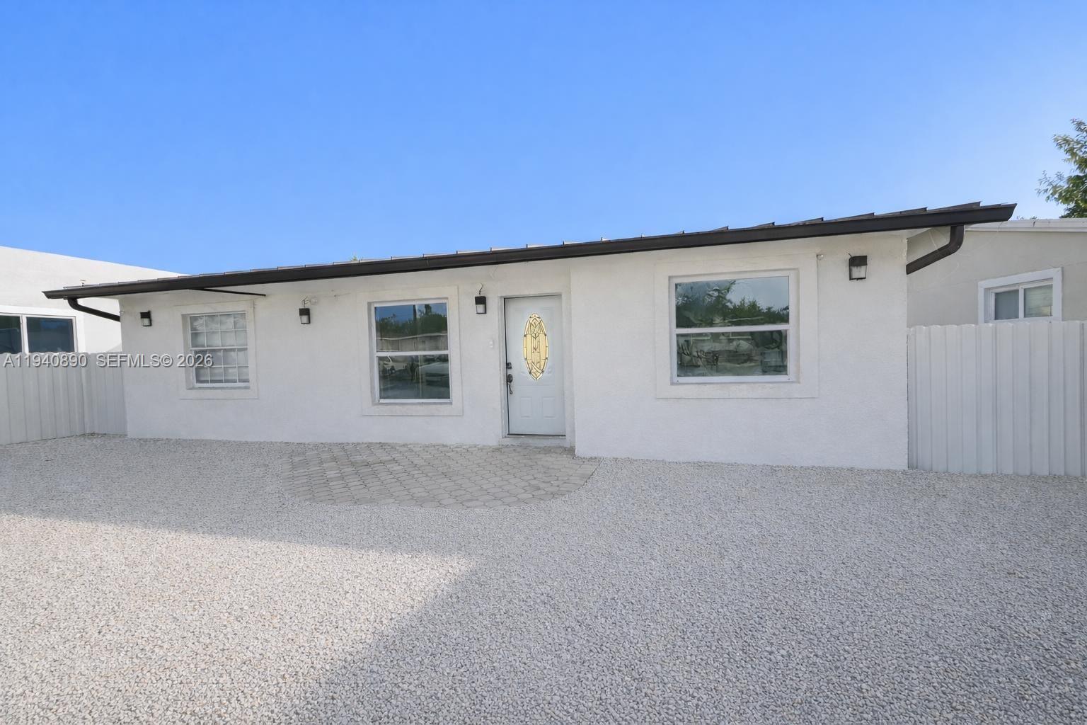 Beautifully remodeled property offering ample parking for multiple vehicles. The home includes an RV with its own private entrance, currently generating $1,150 per month in rental income. A brand-new aluminum roof was installed in 2022. Property taxes are currently elevated due to the roof loan, which will be paid off at closing, resulting in a significant reduction in taxes for the new owner. Ideally located near the Florida Keys, outlet mall, shopping centers, schools, the popular Robert Is Here attraction, and just minutes from Everglades National Park.