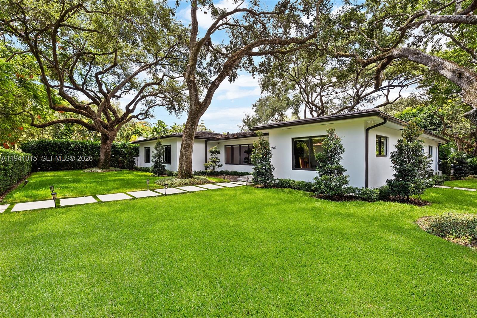 Fully renovated 3 bedroom, 4 bath contemporary corner residence in the heart of Coral Gables Golden Triangle area. This home features an open floor plan with wood floors throughout, a fenced yard with heated pool and spa, surrounded by beautifully landscaped, meticulously trimmed oak trees with lighting. Additional highlights include a two-car air conditioned garage, freshly painted interior and exterior, a new laundry/storage room, Lutron lighting system, NVR hardwired security cameras with app access, and TVs included. Space to expand square footage.