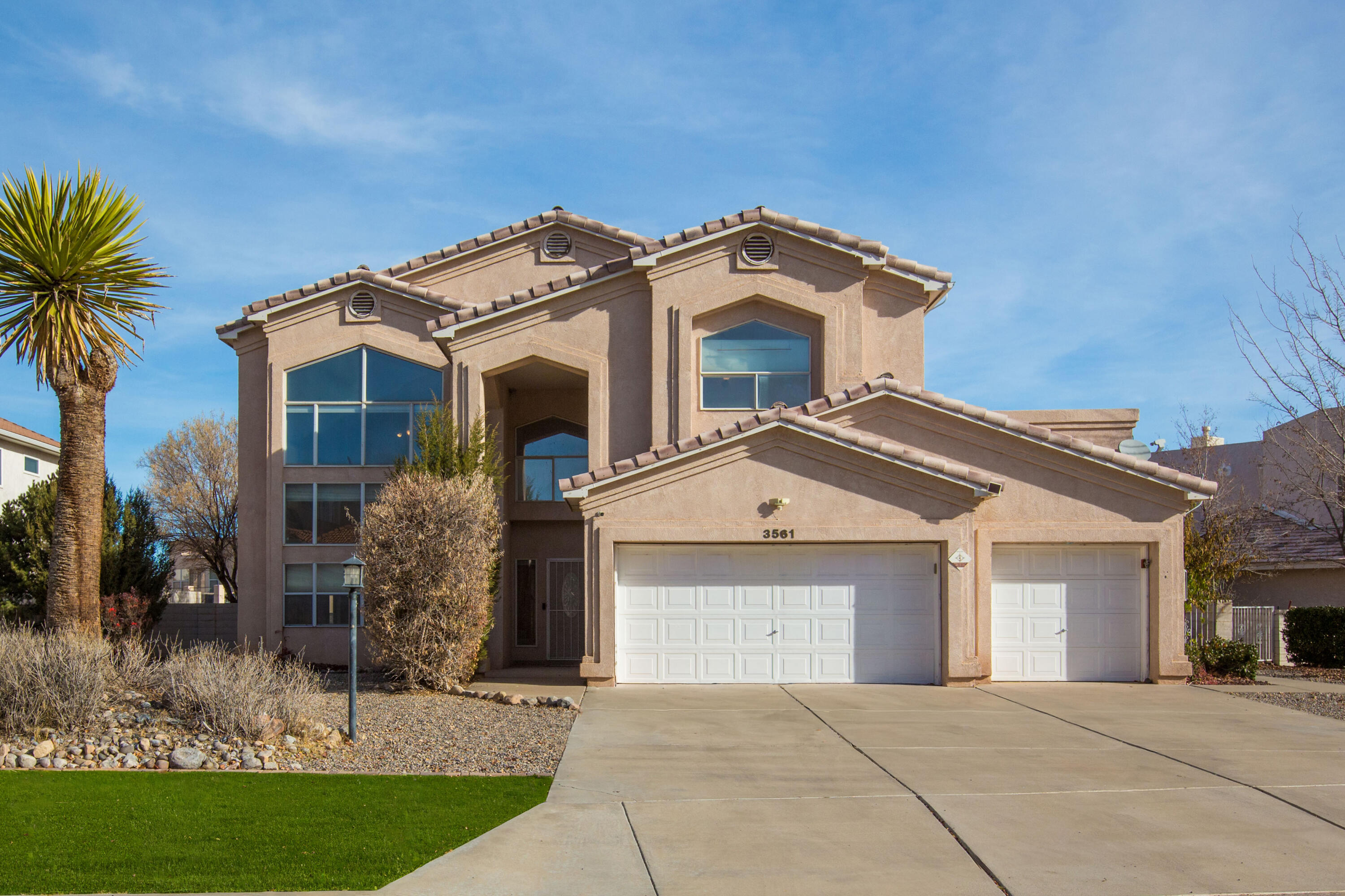 Discover this semi custom home offering over 3,400+ sqft in the Former Rio Rancho Executive Golf Community. This spacious home features OWNED Solar for energy efficiency, 4 bedrooms and 3+ bathrooms, including 2 primary suites--one on main level and one on upper level, providing flexible living for guests, multi-generational households, or private retreats.  The open-concept kitchen is ideal for entertaining, flowing seamlessly into the living and dining areas. Enjoy year-round comfort with 2 new evap coolers and a new 50-gallon hot water heater, along with the added benefit of . Outdoor living is a standout feature with three patios (one covered), two balconies, and backyard access, all set within a beautifully landscaped yard that offers a peaceful and private retreat.