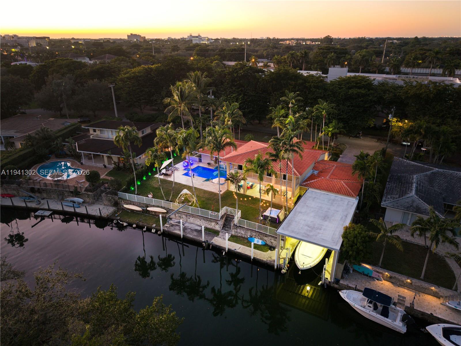 Exceptional 6BD/4.5BA and 2 car garage waterfront residence on the Coral Gables Waterway boasting 132.5’ of water-frontage, a large concrete dock, and a coveted 40’ covered boathouse with a 18,153 lot —a true boater’s dream. Enjoy sweeping canal views from nearly every bedroom, with unparalleled down-the-waterway vistas from the primary suite and upstairs balcony. The open-concept living areas capture the waterway from multiple angles, creating a seamless indoor-outdoor connection. A covered patio with wet bar overlooks the heated saltwater pool which has three water features. New appliances and impact windows and doors. An exceptional opportunity for the avid boater or waterfront enthusiast.