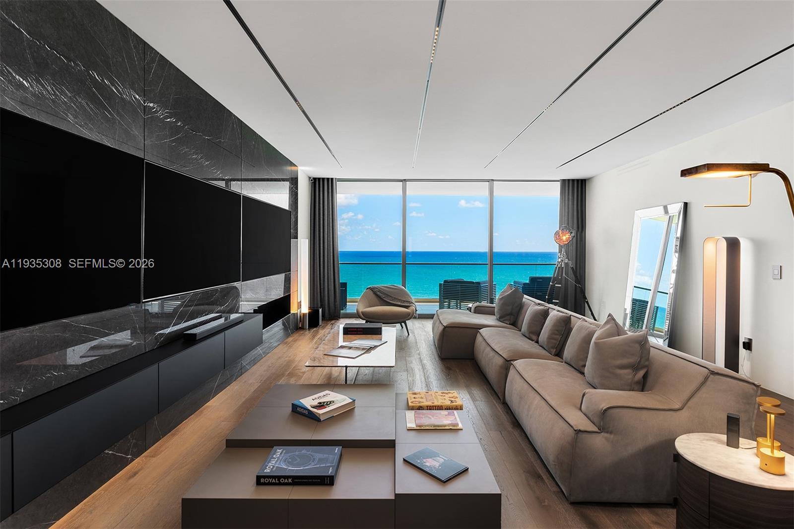 Rare opportunity in Bal Harbour. This exceptional direct oceanfront residence includes three parking spaces and three private storage units, a truly uncommon offering. Designed by the renowned YODEZEEN Architectural Firm, the 3,345 SF turnkey home captures sweeping views of the Atlantic Ocean, Biscayne Bay, and the Miami skyline. Interiors feature marble and wood floors, 10 ft ceilings, private elevator access, and custom closets throughout. The sleek Dada kitchen is appointed with Calacatta marble countertops and premium Gaggenau appliances. Residents enjoy dual oceanfront pools, spa, tennis courts, and a state-of-the-art fitness center, just steps from Bal Harbour Shops, offering a rare balance of privacy, prestige, and effortless coastal elegance.