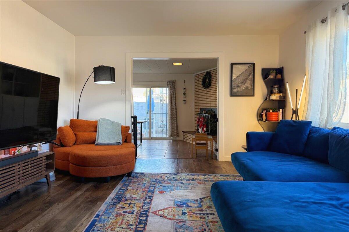 Welcome to this beautifully updated NE Heights home in the desirable Eldorado High School District! This home features two primary bedrooms, including a freshened up primary bath, newer luxury vinyl plank flooring, recessed lighting, fresh interior paint, and stylish finishes throughout. Recent updates include a new TPO roof (2024 with warranty to 2035).The remodeled kitchen shines with a newer refrigerator, oven, and microwave. Dual living areas offer flexible, multifunctional spaces, complemented by a cozy wood-burning fireplace. 2 Car garage with separate doors, 210VT, and cabinetry. The driveway can fit 3 cars. Step outside to a large backyard with a patio and shed, plus possible side yard access--perfect for storage or outdoor toys.