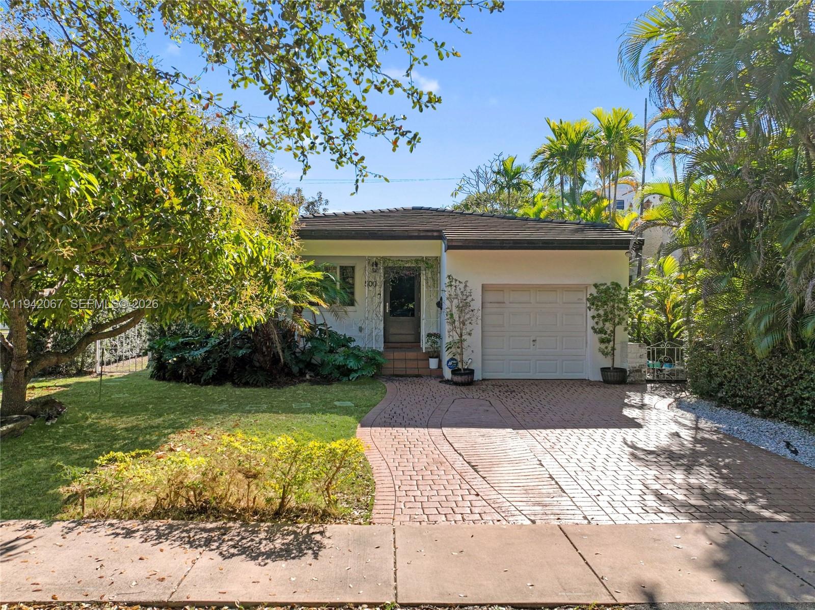 Enjoy the best of urban convenience and single-family living in the heart of Coral Gables. Just one block from the shops and dining of Downtown Gables, this charming 3-bedroom, 2-bath home offers a bright, open layout with warm wood flooring, plantation shutters, and impact windows throughout. The well-equipped kitchen features stainless steel appliances, granite counters, and ample cabinetry, flowing into a spacious living and dining area ideal for entertaining. French doors open to a private backyard retreat with a patio, barbecue zone, and a mature mango tree—perfect for al fresco gatherings. The 2018 tile roof, one-car garage, and additional driveway parking enhance everyday ease. Located within the desirable Coral Gables K-8 Preparatory School district and surrounded by excellent pre-K options, this home combines lifestyle, location, and timeless Coral Gables charm.