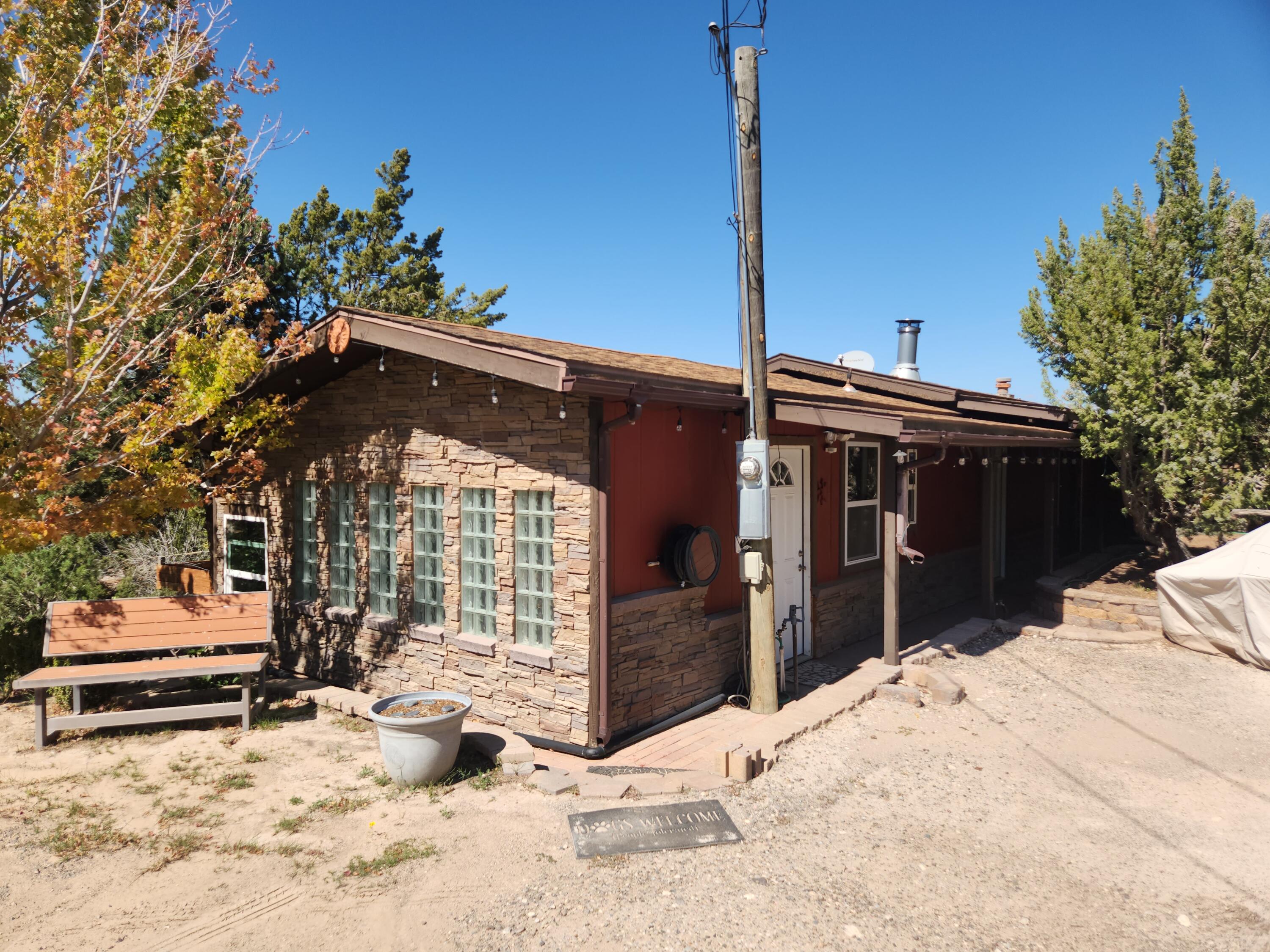 2 HOMES ON 3 ACRES! ONLY $275,000. Main house is 2 BR + Office, 1.5 BA, 1798 sq ft. 2nd home is 3 BR, 2 BA, 1390 sq ft & has been used as a separate rental. Both homes are part manufactured homes (offsite built) with additions. There is NO mortgage financing available as the homes are not totally on permanent foundations. So it must be cash or the owners will consider owner financing with 50% down. Both homes have full kitchens. There are separate gates to access each home. The homes are about 200 feet apart, so each is very private! There are tons of trees, as water is shallow and plentiful in this part of Placitas! Water well serves both houses; each home has its own septic system & electric. Both septic systems were recently pumped & passed inspection. 2 car carport. 3 storage  sheds.