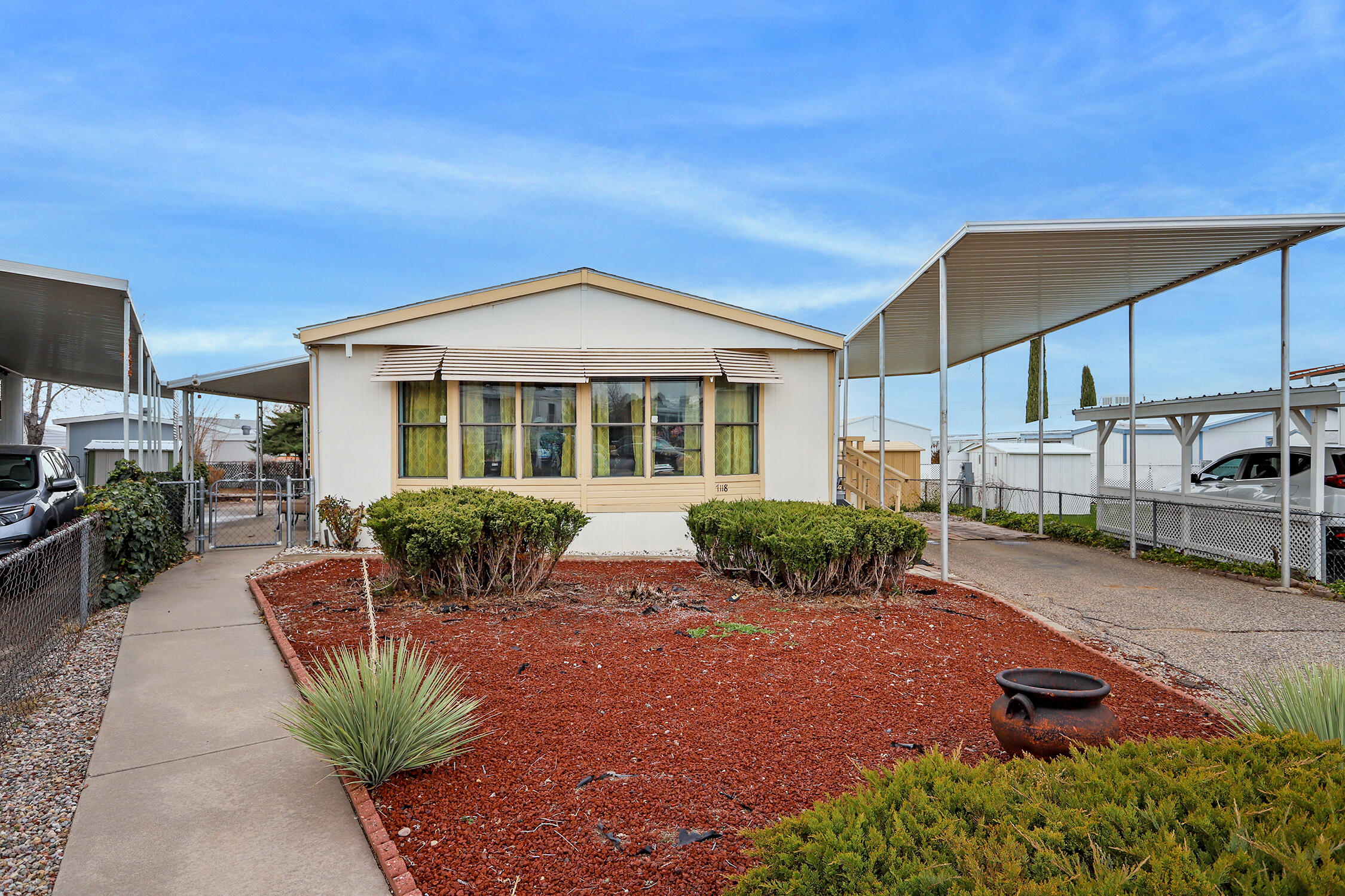 North Hills 55+ Gated Community - Updated, move-in ready home with large windows facing the Sandia Mountains. All appliances included. $656/monthly includes recreation center, swimming pool, tennis court and club house. Land lease,  Buyer to verify all costs.