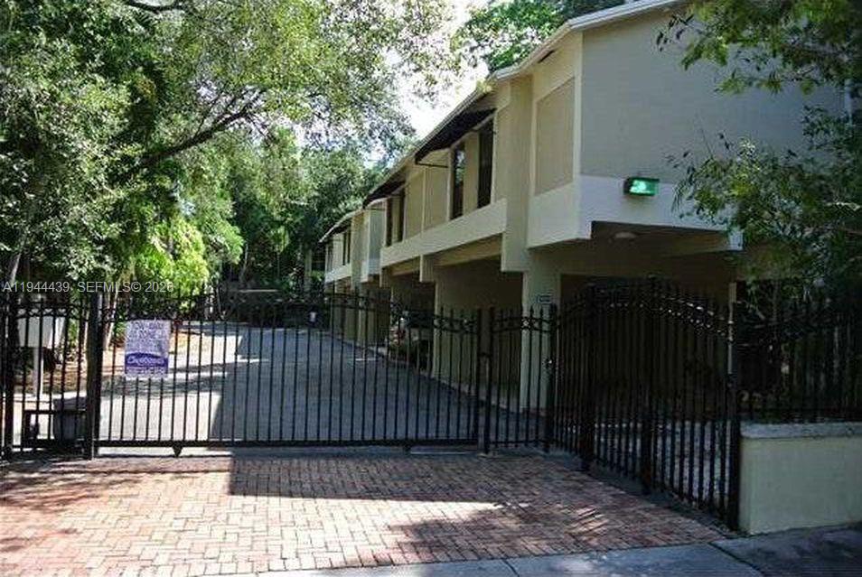 Great corner unit Townhouse Coconut Grove. Located in a very nice gated community with only 10 units. Walking and biking distance to the water, restaurants and shopping district. Property has a great shaded patio area that wraps around to a private entrance. The two large bedrooms have their own private bathrooms located on the second floor and guest bathroom on the first floor. Carport for two cars. Blanche park located across the street. A great place to live.