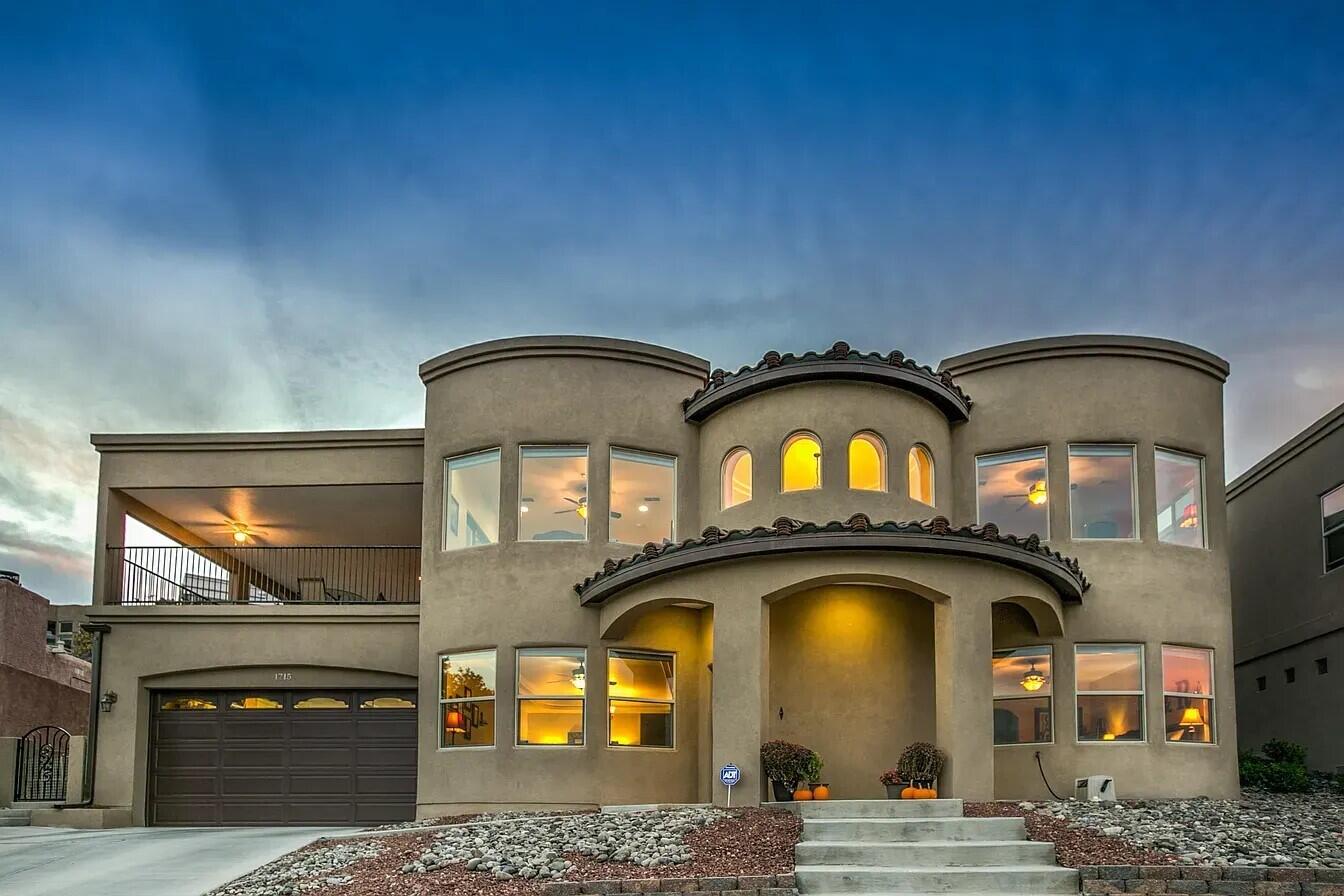 Experience luxury living with breathtaking views of the Sandias, the Bosque, and downtown! This custom-built masterpiece features a bright, open layout centered around a gourmet kitchen with granite countertops, double ovens, stainless steel appliances and an oversized island. The main-floor primary suite offers a spa-like retreat with dual vanities, a jetted tub, walk-in shower, and a massive walk-in closet. Upstairs, discover a flexible office or 4th bedroom and two additional bedrooms with a Jack-and-Jill bath. The outdoor oasis is built for entertaining, boasting an expansive balcony with a tiered yard, and plenty of space to relax or play. A masterpiece of comfort, craftsmanship, and style. Don't miss this stunning home! Schedule your private showing today.