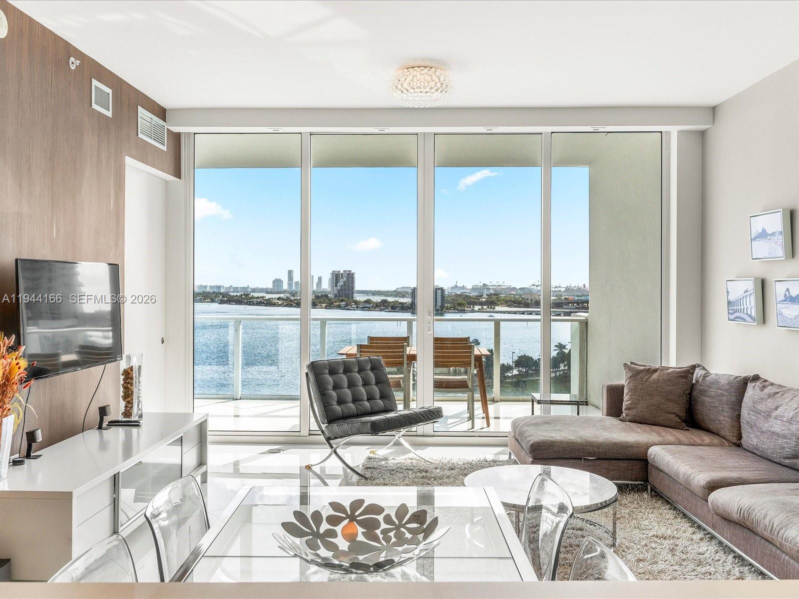 Enjoy unobstructed views of the bay and the Miami Beach skyline from this beautifully designed residence. Offered fully furnished, this turnkey condo features 1,135 sq. ft. / 105.44 m² of well-planned living space, including 1 bedroom, 2 bathrooms, and a den that comfortably serves as a second bedroom with a queen-size bed.Finished with white porcelain tile throughout, electric blinds, and top-of-the-line appliances, the home offers a bright and elegant ambiance. Paramount Bay provides exceptional amenities, including two pools, cabanas, a spa, game and toddler rooms, an events lounge, and 24-hour concierge, security, and valet services—delivering a refined and effortless Miami lifestyle.