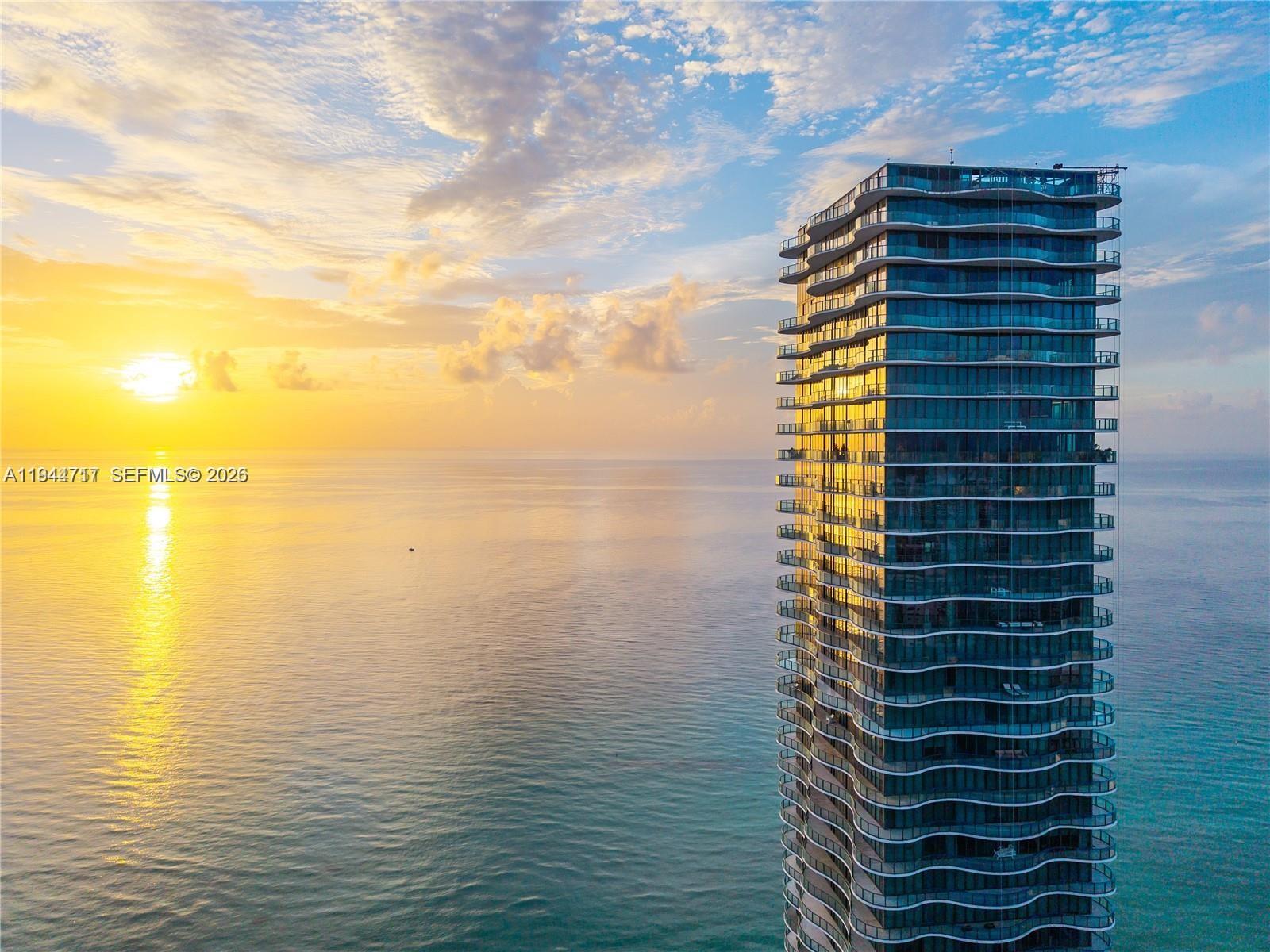 Award-winning, full-floor oceanfront residence at Regalia, offering the privacy and scale of a private home with the services of a boutique luxury condominium. Accessed via a private elevator, this all-glass residence features approximately 5,000 SF of interior living space and a 2,100 SF wraparound terrace with breathtaking 360 degree views of the Atlantic Ocean, Golden Beach, the Intracoastal Waterway, and the Miami skyline. Designed for entertaining, the expansive living and dining areas are wrapped in 10-ft floor-to-ceiling glass, filling the home with natural light and uninterrupted ocean vistas. Every room enjoys direct terrace access, creating seamless indoor-outdoor living throughout. The residence has been fully reimagined with no expense spared, showcasing grey and marble slab finishes, integrated smart lighting and automated window treatments. The chef’s kitchen features custom Italian cabinetry, exotic stone countertops, and top-of-the-line Sub Zero& Miele appliances. The primary suite is a private retreat with dual spa-style marble bathrooms, rain showers, soaking tub, and generous custom closets. Offered fully furnished & curated by Artefacto. Regalia offers full-service luxury amenities, including beach and pool service with cabanas, concierge, spa, fitness and yoga studios, private wine cellar, business center, library, and children’s playroom—delivering an exceptional oceanfront lifestyle.