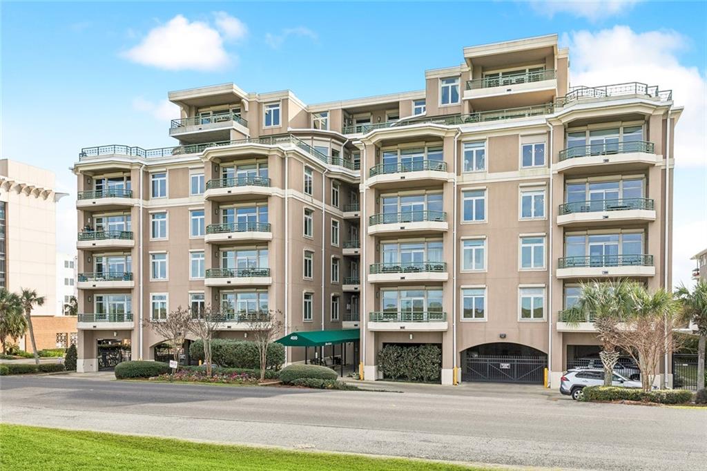 Discover this stunning 2-bedroom, 2-bathroom residence that offers an impressive 1,770 square feet of living space and a total of 1,836 square feet—a scarce find! This unit also includes two covered parking spaces and a dedicated storage unit for your convenience.As you enter, a beautiful foyer welcomes you into the open-concept living and dining areas, where large windows provide breathtaking views of the lake from your personal balcony—a perfect spot for relaxation. The primary bedroom is a true sanctuary, featuring an en suite study fitted with custom-built shelving and cabinets. The spacious primary suite boasts a built-in bed unit with an upholstered headboard, plus matching side table and dresser units for a polished look. You’ll fall in love with the expansive 18.9' x 9.7' walk-through designer closet—every homeowner’s dream! The primary bath exudes luxury with ample counter space and a gorgeous stone shower.Culinary enthusiasts will appreciate the kitchen, offering generous counter space, stylish cabinetry, and a Sub-Zero wood-paneled refrigerator. The kitchen features a stainless steel backsplash and high-end appliances, including a Dacor stove/oven, Miele dishwasher, Sharp convection microwave, and warming tray, complemented by under-cabinet lighting, a walk-in pantry, and additional shelving.The second bedroom is generously sized and includes its own beautifully designed bathroom and closet. With soaring 10-foot ceilings throughout, the unit feels even more expansive.This property features outstanding amenities: a welcoming reception area, 24/7 security with a guard station, and an entertainment room with a full kitchen, bar, dining area, and theater. Enjoy splendid outdoor living with views of a large pool, cabana, and BBQ area, as well as a lush greenhouse surrounded by verdant landscaping. Plus, this unit is equipped with both automatic and manual hurricane shutters for peace of mind.Don’t let this exceptional opportunity slip away!