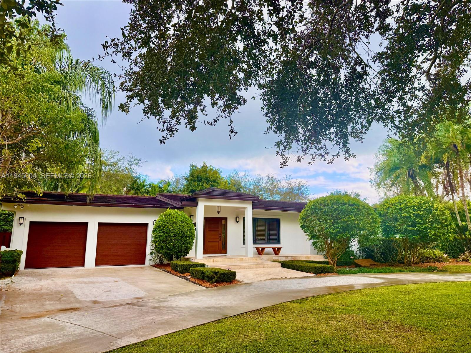 Gorgeous entirely remodeled estate with rare space, privacy, refined modern living across 0.93 acres along the Palmetto Bay/Pinecrest boundary.Exceptional residence, generous living areas, chef's kitchen, oversized master suite, new bathrooms. Expansive glass doors open to a park-like yard, new landscaping, mature oak and fruit trees, 2 pergolas, spectacular heated pool with saltwater system, waterfall, and spa, and a full summer kitchen. Additional highlights include impact windows and doors, indoor-outdoor speakers, security cameras, 2-car garage with EV charger, ample guest parking, and rare dual street access, ideal for boat storage. A perfect layout for families, close to top-rated schools, parks, and great malls, and to enjoy resort-style living in one of the most desirable enclaves.