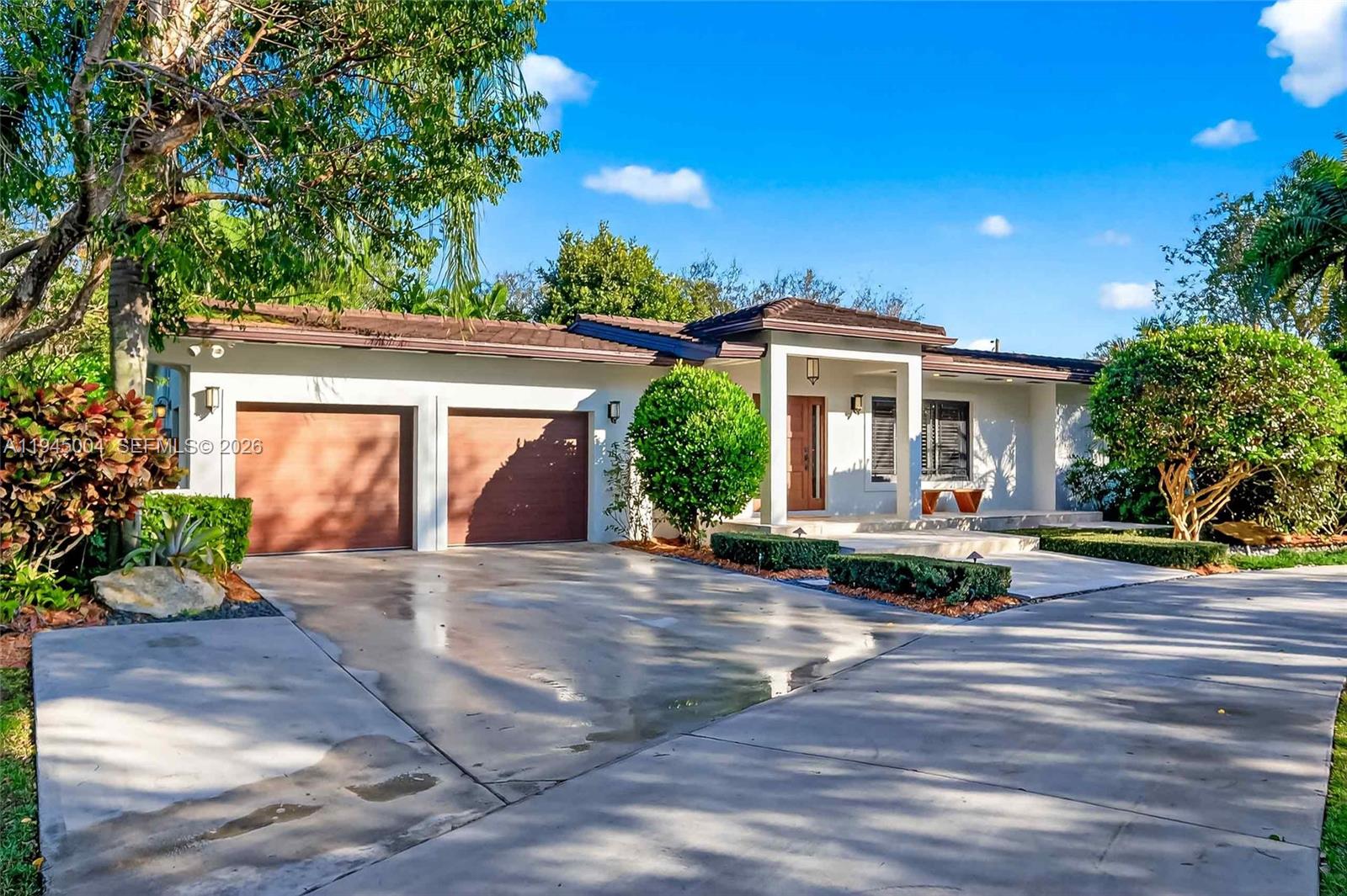 Gorgeous entirely remodeled estate with rare space, privacy, refined modern living across 0.93 acres along the Palmetto Bay/Pinecrest boundary.Exceptional residence, generous living areas, chef's kitchen, oversized master suite, new bathrooms. Expansive glass doors open to a park-like yard, new landscaping, mature oak and fruit trees, 2 pergolas, spectacular heated pool with saltwater system, waterfall, and spa, and a full summer kitchen. Additional highlights include impact windows and doors, security cameras, 2-car garage with EV charger, ample guest parking, and rare dual street access, ideal for boat storage. A perfect layout for families, close to top-rated schools, parks, and great malls, and to enjoy resort-style living in one of the most desirable enclaves.