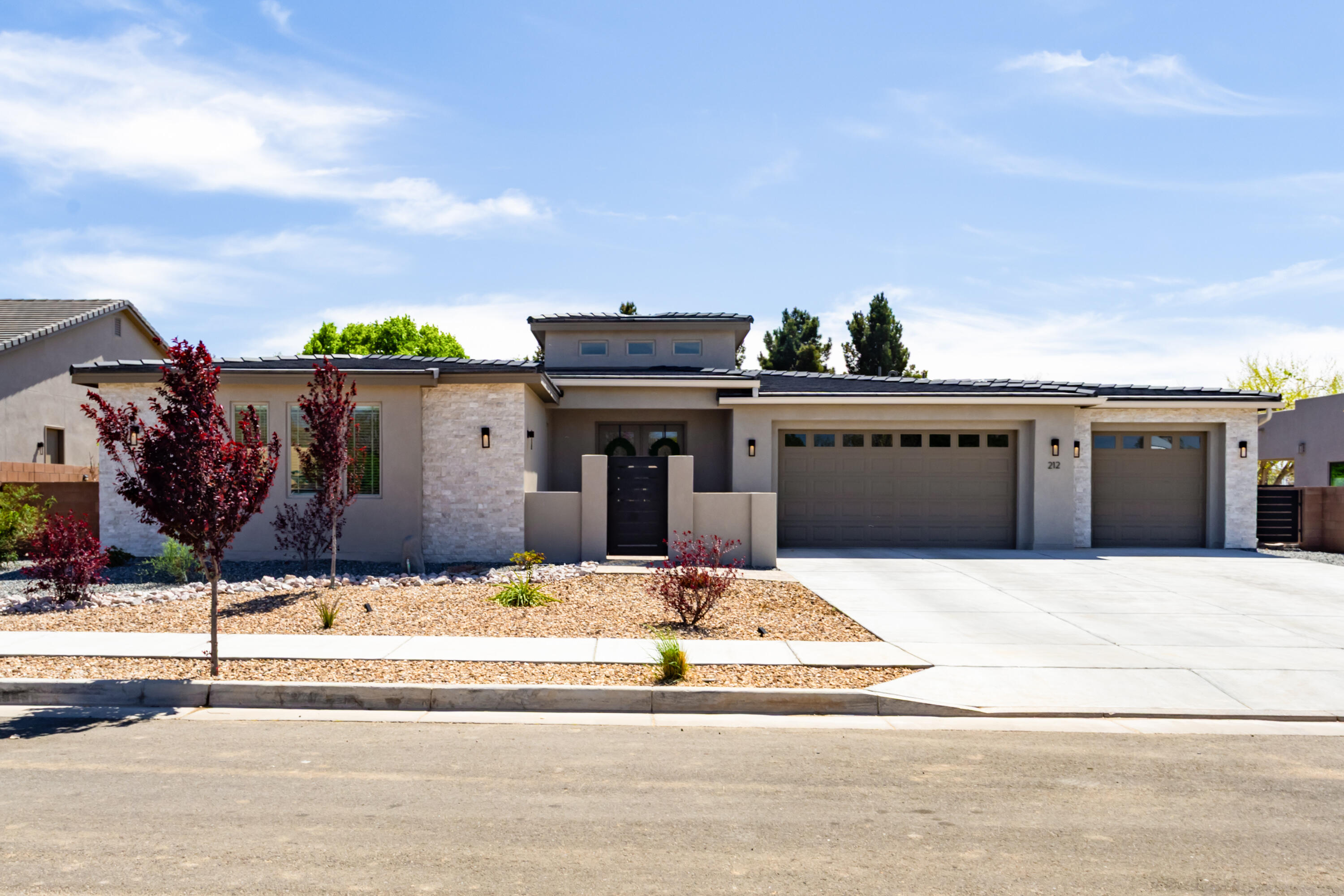 Located in a small gated cul de sac of Luxury Custom homes in the North Valley. Home sits on a BEAUTIFULLY landscaped 1/3-acre lot, this stunning custom home offers deluxe living indoor & outdoor.  The open-concept floor plan features 4 spacious bedrooms, 3 baths, and a 3-car garage with epoxy flooring. The chef's kitchen is a true showpiece--boasting quartz countertops, a large center island, custom cabinetry, high-end stainless-steel appliances, and a walk-in pantry. The kitchen flows seamlessly into the family room with a remote-controlled fireplace and impressive 16-foot sliding doors that open to the expansive outdoor living space.The covered patio is perfect for entertaining, featuring an outdoor kitchen with built-in grill, refrigerator, sink, ceiling fans, & TV.