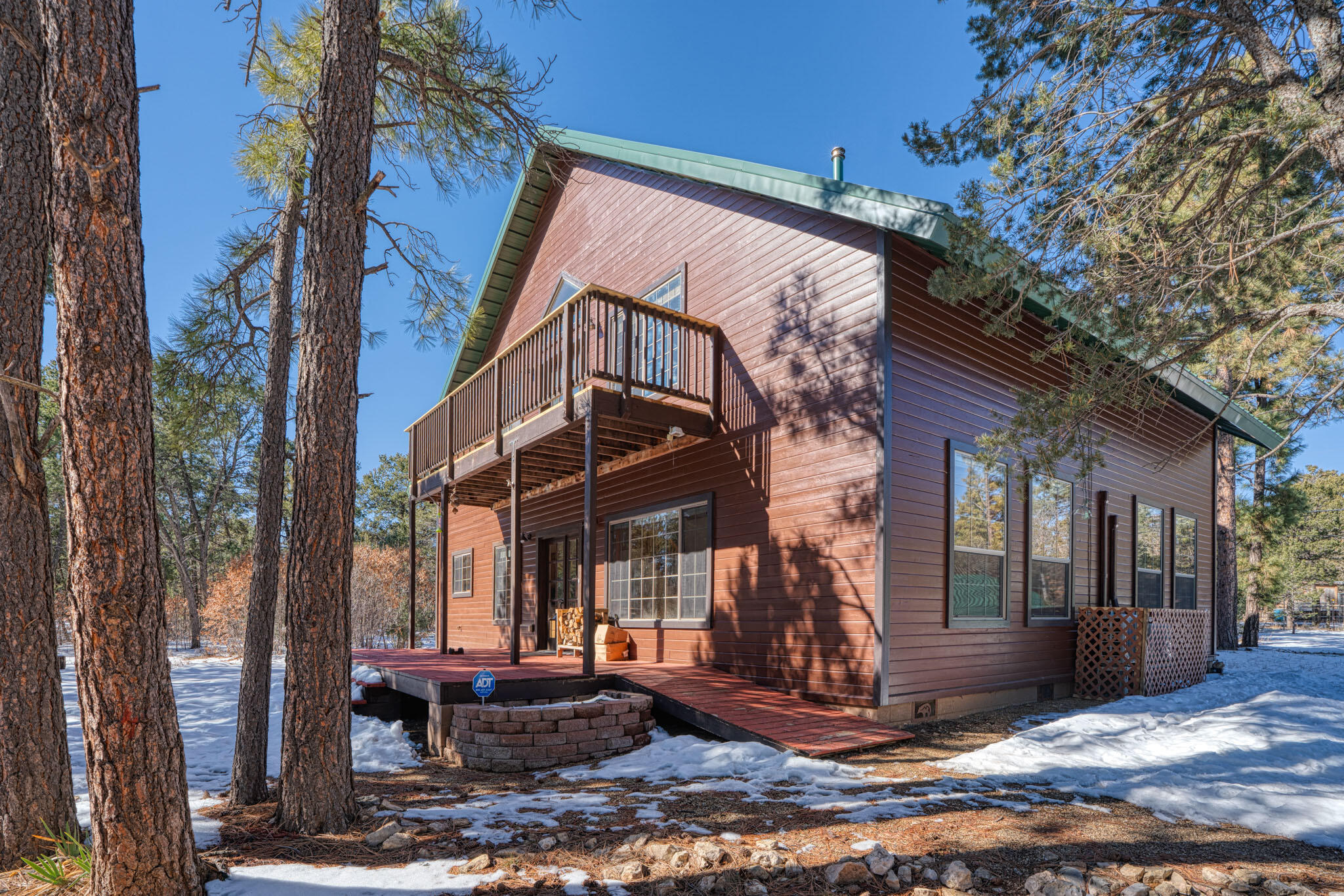 Tucked among the trees, this mountain-style Tijeras home offers a peaceful retreat on 2 private, wooded acres--fully fenced and gated for added seclusion. The 3-bedroom, 2.5-bath layout features generously sized rooms, including a main-level primary suite w/ a jetted tub & separate shower. A spacious living room with woodstove flows into a large kitchen with island, generous pantry, three ovens, and an inviting dining area. Upstairs, a huge loft provides flexible living space. Kona wood flooring and tile add warmth throughout. Recent upgrades include a metal roof, soffits and fascia, water heater, washer and dryer, Kinetico water filtration system, mini-splits throughout, a rebuilt upper deck, and fresh interior and exterior paint. Additional finished spaces not included in square footage.