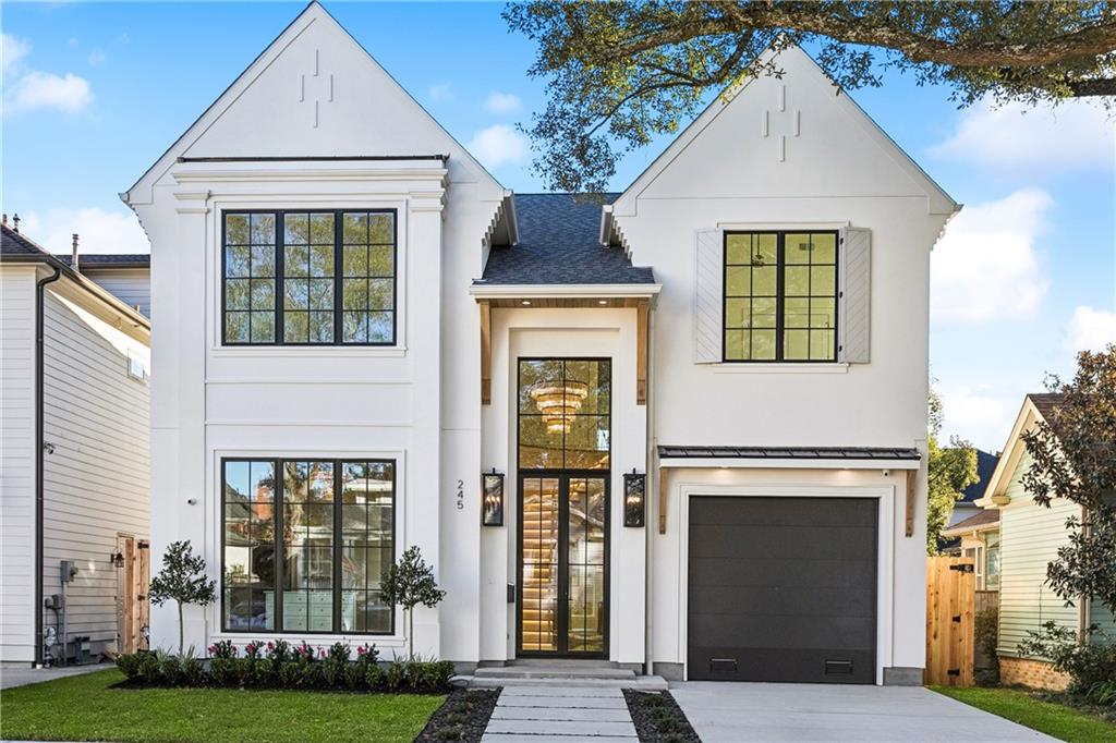 Located in the highly sought after Old Metairie neighborhood, this new construction home blends timeless design with modern luxury. The exterior offers exceptional curb appeal, complete with off-street parking and a garage. A dramatic 16-foot front door entry featuring a 10-foot door topped by a 6-foot transom window—floods the foyer with light and highlights a beautifully illuminated curved staircase.Inside, soaring 12-foot ceilings and elegant arches create a sense of openness and sophistication. The primary suite is conveniently located downstairs. The spa-like primary bath connects to a massive walk-in closet with a stackable washer and dryer for added convenience.The gourmet kitchen features a hidden pantry that opens into a fully appointed secondary pantry with cabinetry. Under-cabinet and toe-kick lighting add a warm, inviting glow. The dining room overlooks a custom, climate-controlled wine room with glass doors. Expansive 10-foot sliding doors lead to a rear porch with a built-in outdoor kitchen perfect for entertaining.This 6-bedroom, 4.5-bath home includes an office and offers plenty of space upstairs with five additional bedrooms, three bathrooms, a laundry room, and a loft.