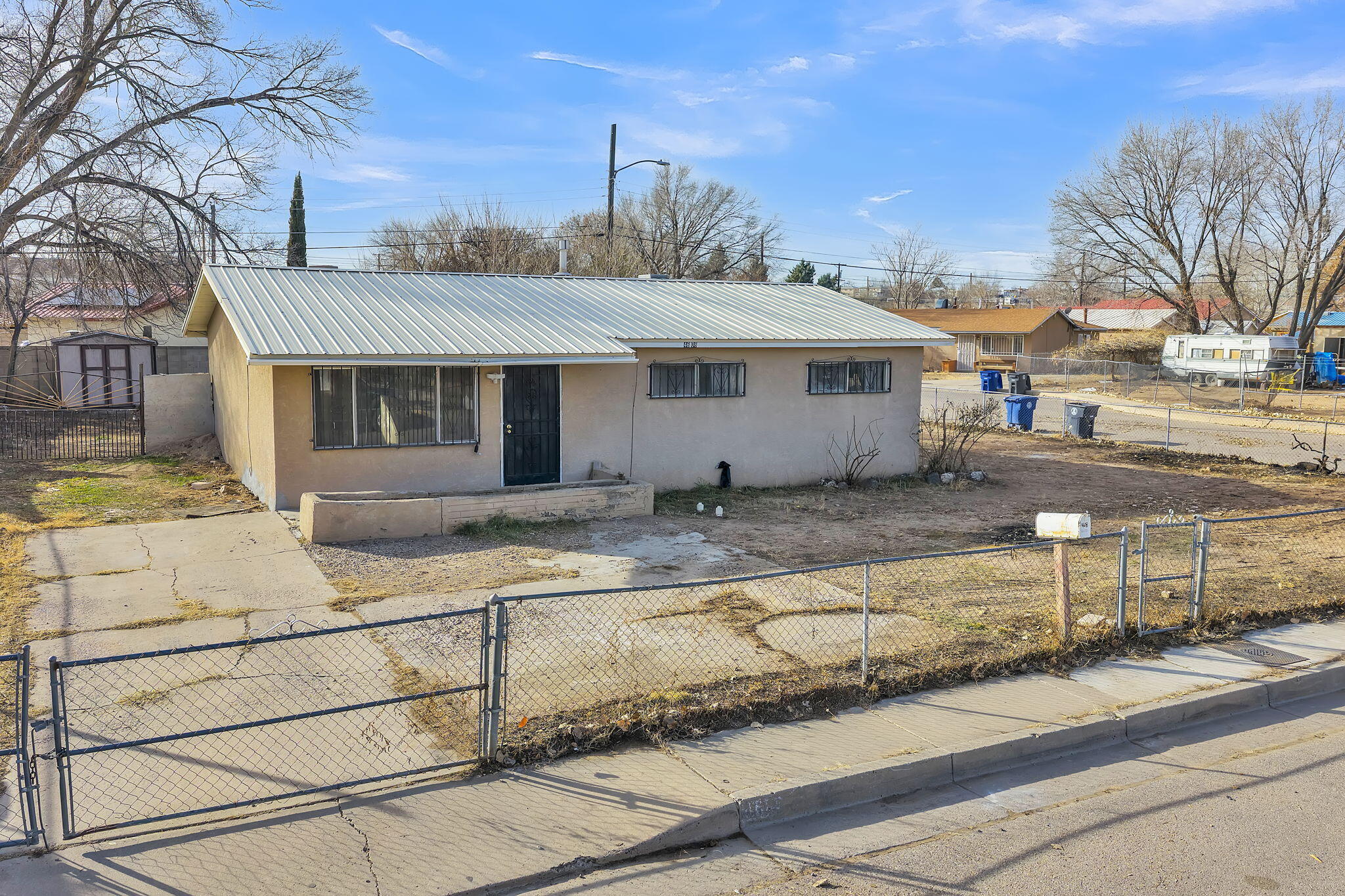 Corner lot home in Northwest Albuquerque featuring 3 bedrooms, 1 bath, a metal roof, refrigerated air, and a detached storage shed. This single-story residence offers a functional layout with a bright living area, tile flooring in the main living spaces, and comfortable bedrooms.The kitchen provides ample cabinetry and connects efficiently to the living areas, supporting a practical day-to-day flow. The fully fenced yard includes convenient backyard access, offering flexibility for outdoor use, storage, or additional functionality. Corner lot placement allows for added outdoor space and versatility. Conveniently located near schools, shopping, dining, and major roadways, this property presents a solid opportunity for homeowners or investors.