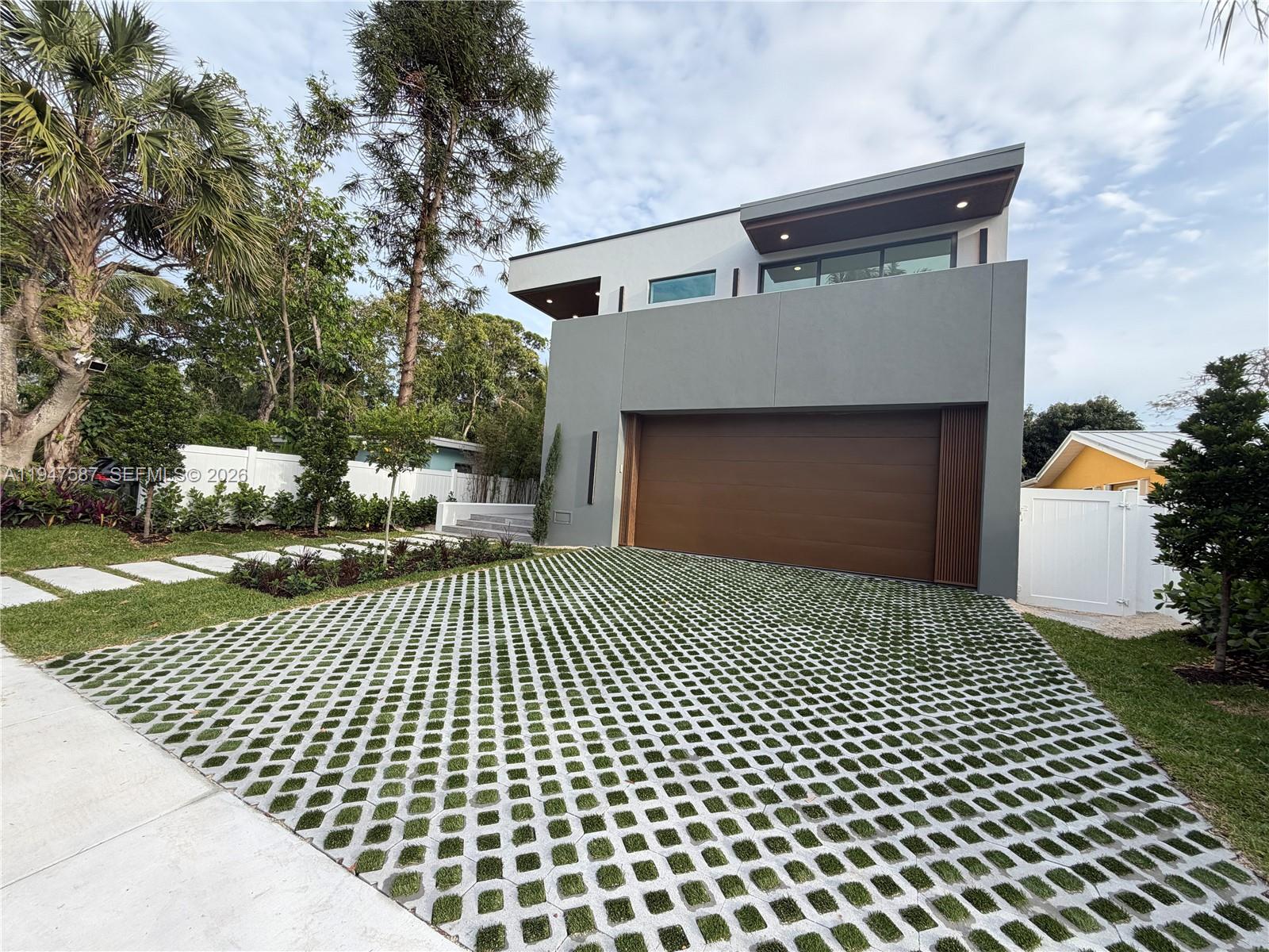 BRAND NEW 2026 CONSTRUCTION- To Be completed April/May 2026. 3347 SQ/FT UNDER AC, AND 4249 TOTAL SQ/FT. Showcasing elevated tropical modern design in a solid all-concrete residence built for strength, durability, and longevity. Enter through a dramatic double-height foyer highlighted by a glass staircase and designer accent walls. The main level offers a seamless open-concept layout with expansive living, dining, and kitchen spaces, plus a full guest bedroom with en-suite bath—ideal for guests or multi-generational living. Upstairs features three additional bedrooms, including a spacious primary suite, a versatile loft for an office or lounge, custom walk-in closets in every bedroom, and a generous walk-in pantry. Outdoors, enjoy a private saltwater heated pool and spa, BBQ area great for family gatherings and entertaining.  Located in Tarpon River, a highly desirable neighborhood just minutes from Downtown Fort Lauderdale, the beach, and the airport.