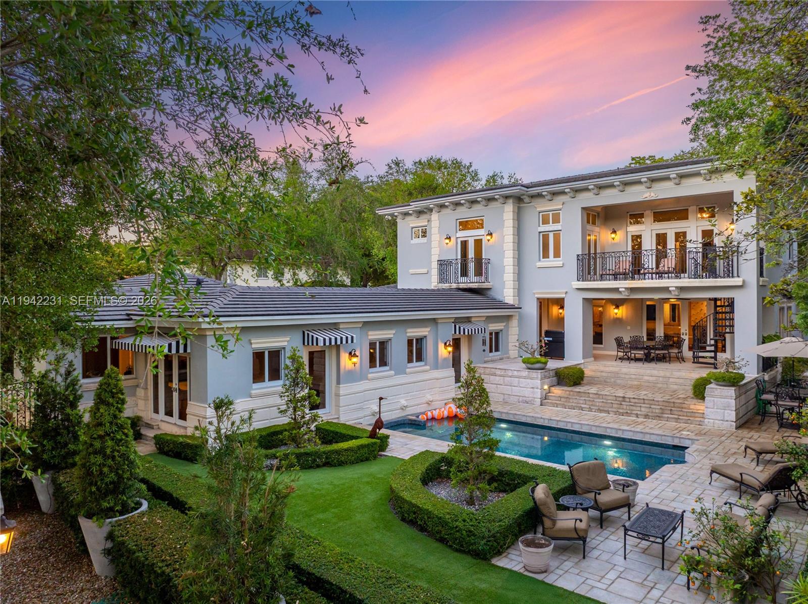 Gables Grandeur! Immaculate French inspired estate directly on the Gables waterway & prestigious Biltmore Golf Course. Situated on an oversized & gated 17,800SF lot with spectacular Vizcaya-like sculptured gardens. Boasting unique character, intricate moldings & craftsmanship throughout w/ 7,451SF of living space. Completely renovated in 2023, the home offers all new bathrooms, bar, laundry room, 2-car A/C garage, roof, & landscaping. Enjoy sophisticated living areas, a top-of-the-line Snaidero gourmet kitchen, & aviary. The grand primary suite offers a serene spa-like bath, expansive closets, office & balcony w/ access to pool & backyard. Grand window-lined corridor leads to attached guest suite w/ 2nd kitchen & living space. Golf cart access onto the fairway + kayak launch from backyard.