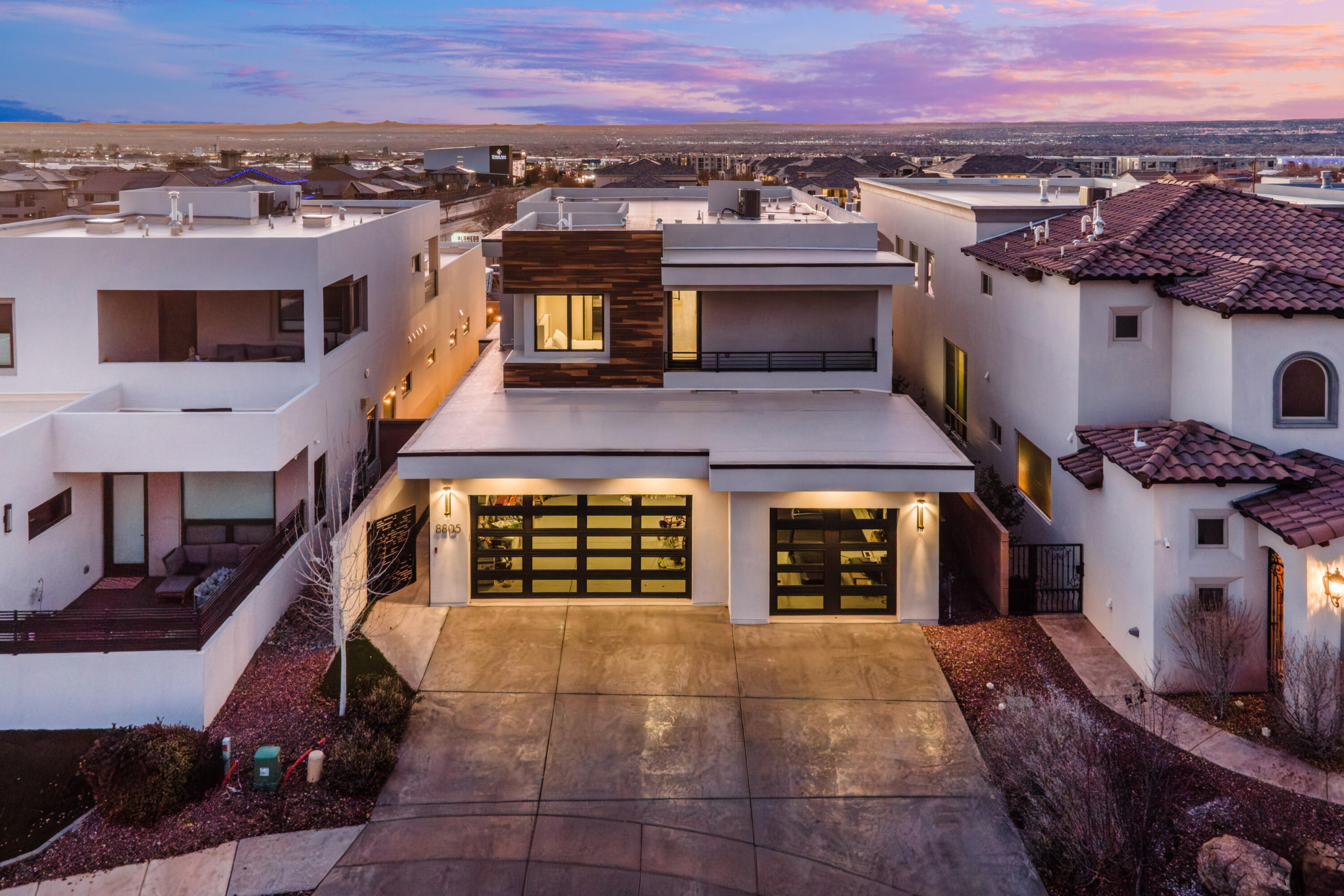 This beautifully maintained modern home is nestled within a small gated community in the desirable North Alb Acres area.  This inviting residence offers a perfect blend of comfort, style, and security.  Step inside to discover a light-filled contemporary interior featuring an open and functional layout designed for both everyday living and entertaining. The home showcases well-appointed spaces, generous room sizes, and thoughtful finishes throughout. The kitchen flows seamlessly into the main living area, creating a warm and welcoming atmosphere for gatherings. The primary suite is located on the main level and provides a relaxing escape with ample space and privacy.   Three additional bedrooms upstairs, two ensuite, plus a spacious loft. Two balconies provide mountain AND city views!