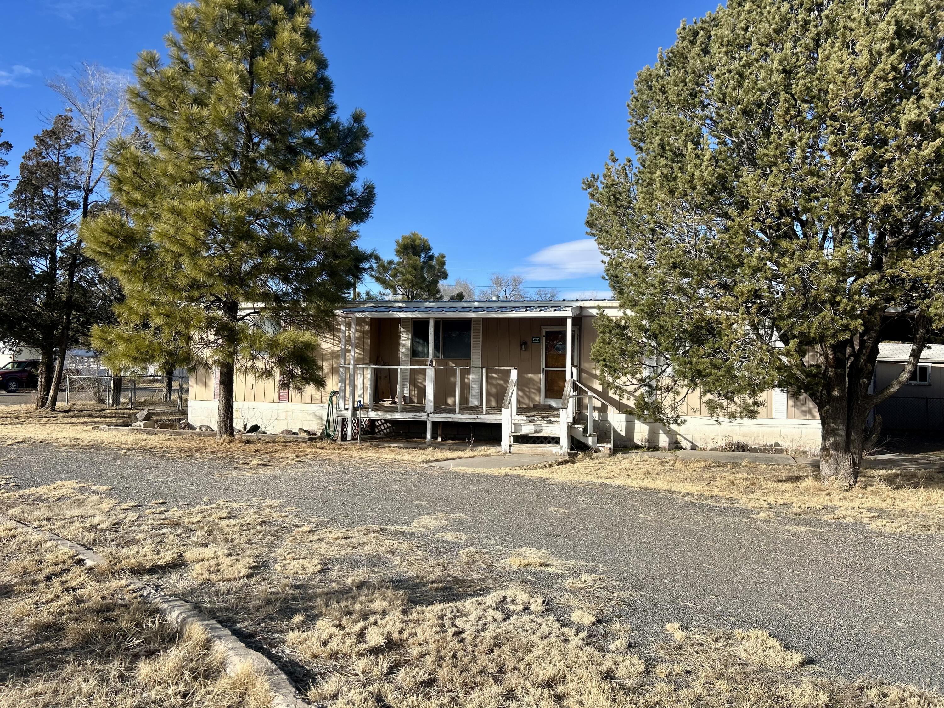 Welcome to Estancia, New Mexico! This well-maintained 1971 double-wide mobile home (24 x 55) sits on a desirable corner lot and offers comfortable small town charm. . The home features 3 bedrooms, 2 bathrooms, a convenient carport, and a fully fenced backyard--perfect for pets, gardening, or outdoor enjoyment.The floor plan provides a practical layout with generous living space and great natural light. The corner lot adds extra privacy and curb appeal, making this a wonderful opportunity for full-time living, rental potential, or a weekend retreat.Enjoy small-town charm with room to make it your own in Estancia.